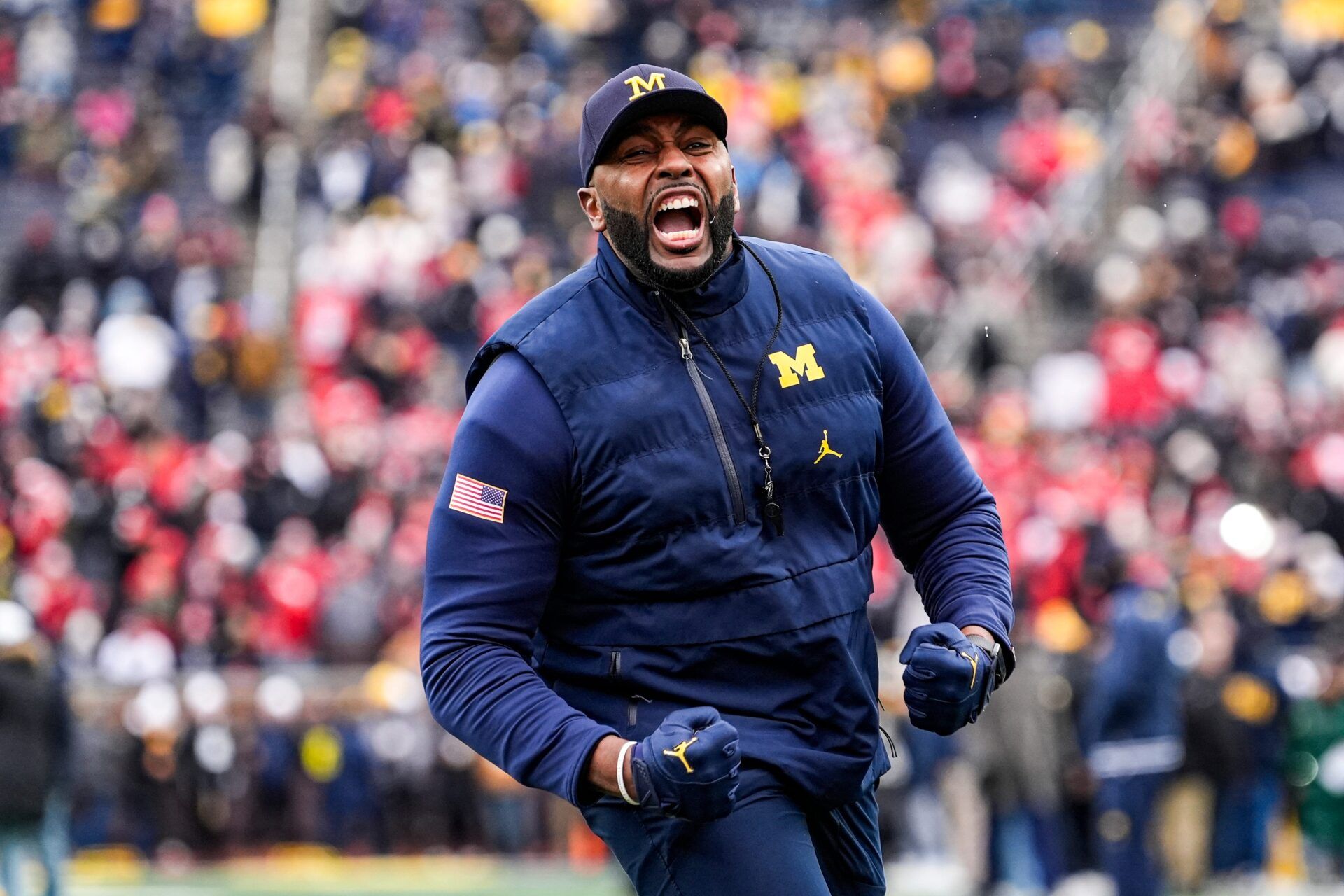 Michigan head coach Sherrone Moore cheer on as he runs onto the filed for warmup at Michigan Stadium in Ann Arbor on Saturday, Nov. 29, 2025.