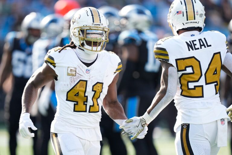 New Orleans Saints running back Alvin Kamara (41) high fives New Orleans Saints running back Devin Neal (24) during the second quarter against the Carolina Panthers at Bank of America Stadium.