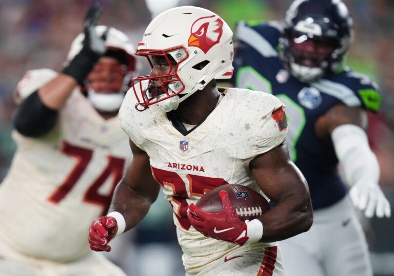 Arizona Cardinals running back Trey Benson (33) breaks out of the backfield against the Seattle Seahawks at State Farm Stadium in Glendale, on Sept. 25, 2025.