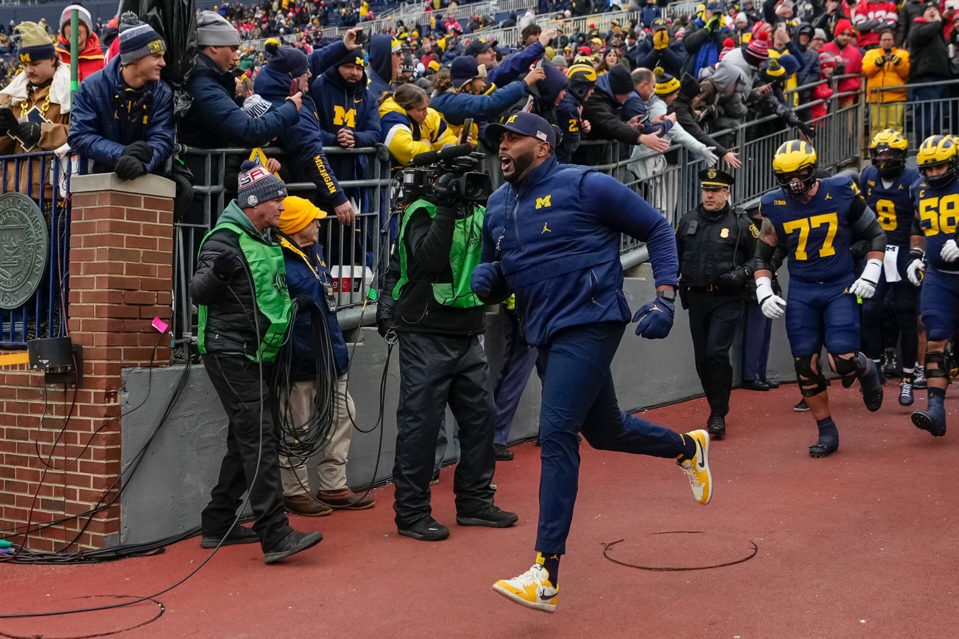 Michigan Wolverines head coach Sherrone Moore leads his team onto the field for warm ups during the NCAA football game against the Ohio State Buckeyes at Michigan Stadium in Ann Arbor, Mich. on Nov. 29, 2025. Ohio State won 27-9.