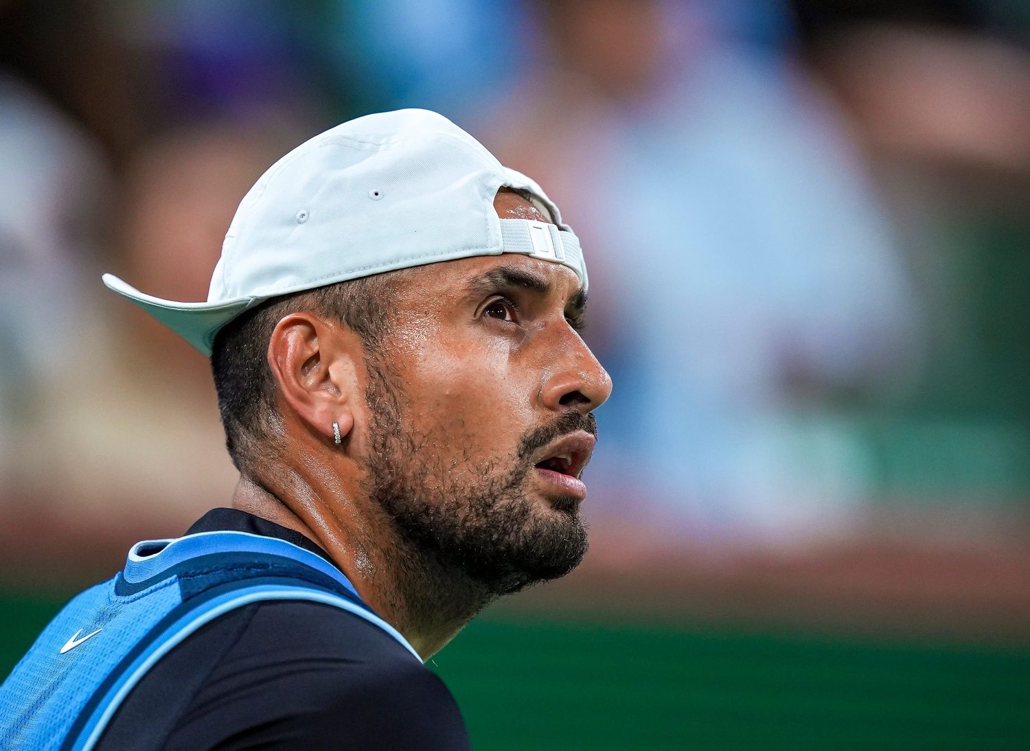 Nick Kyrgios looks up at the video boards before a point against Botic van de Zandschulp in the first set of their first-round match at the BNP Paribas Open in Indian Wells, Calif., Thursday, March 6, 2025.