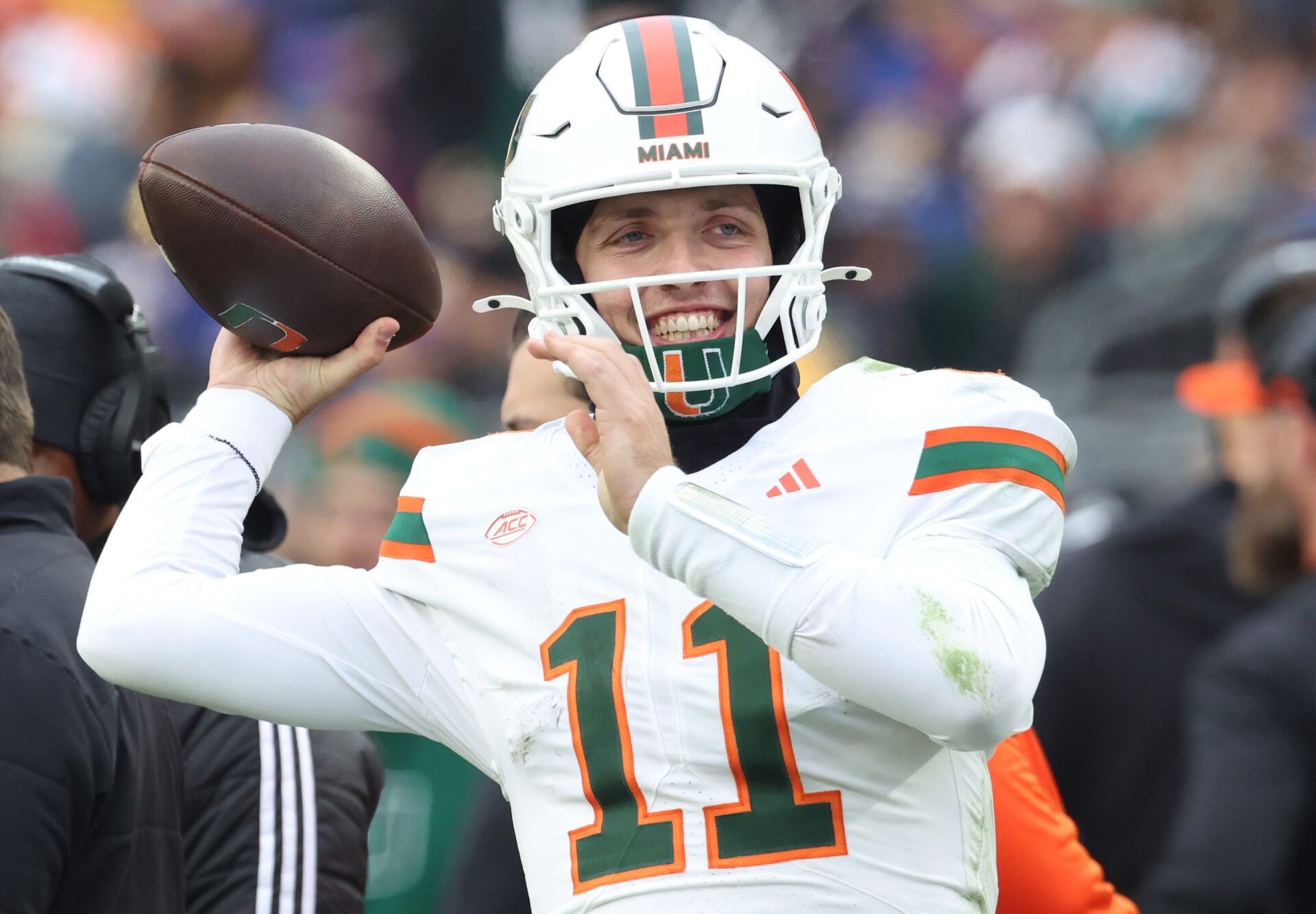 Miami Hurricanes quarterback Carson Beck (11) throws on the sidelines to keep loose during the third quarter against the Pittsburgh Panthers at Acrisure Stadium.
