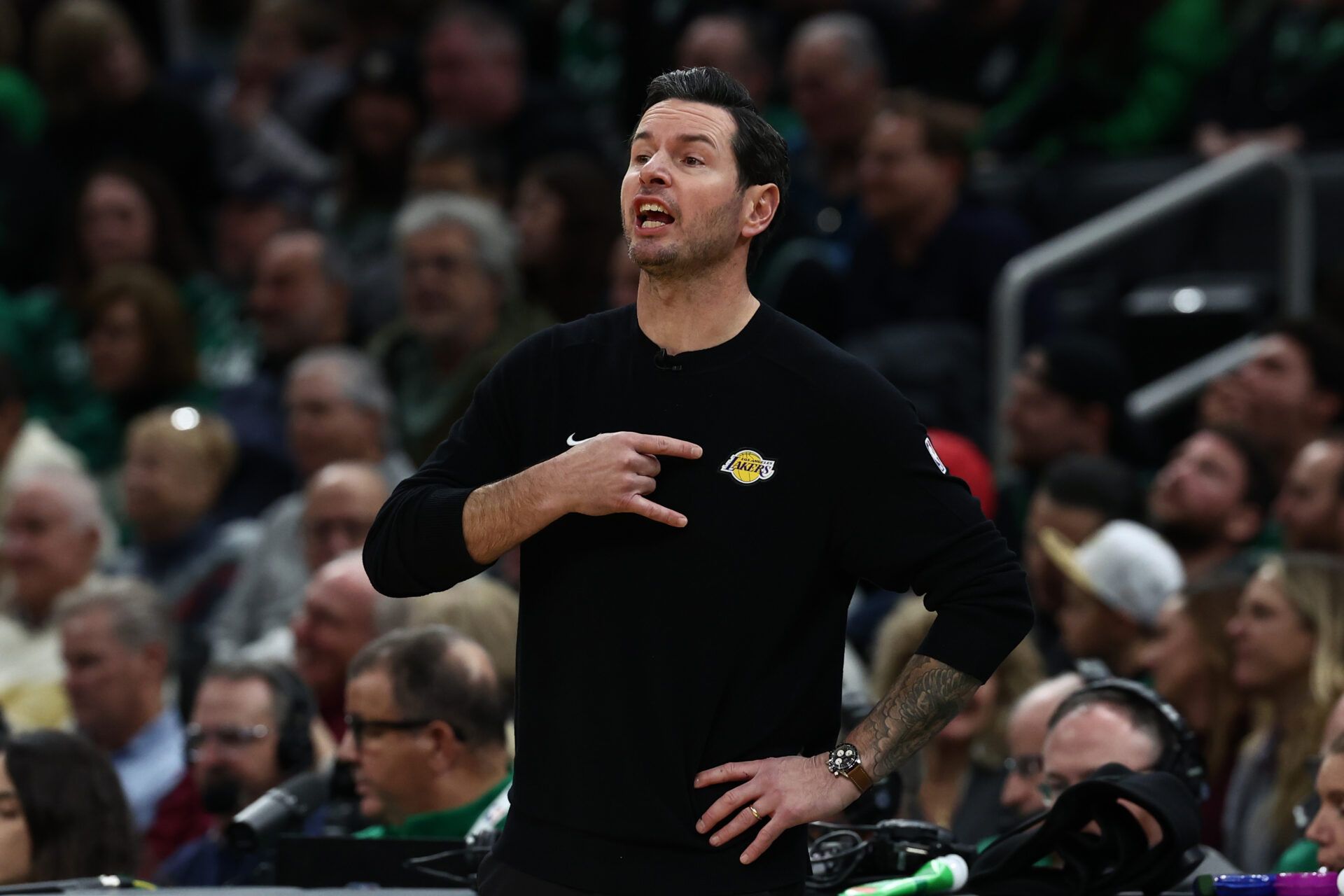 Los Angeles Lakers head coach JJ Redick signals to his players during the first half against the Boston Celtics at TD Garden.