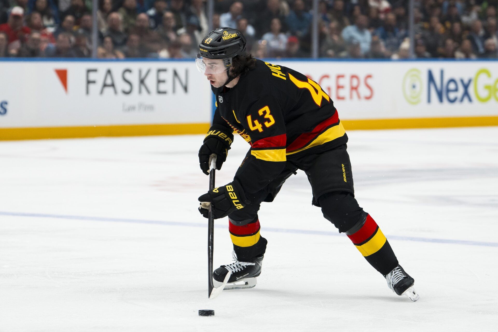 Vancouver Canucks defenseman Quinn Hughes (43) handles the puck against the Detroit Red Wings in the second period at Rogers Arena.