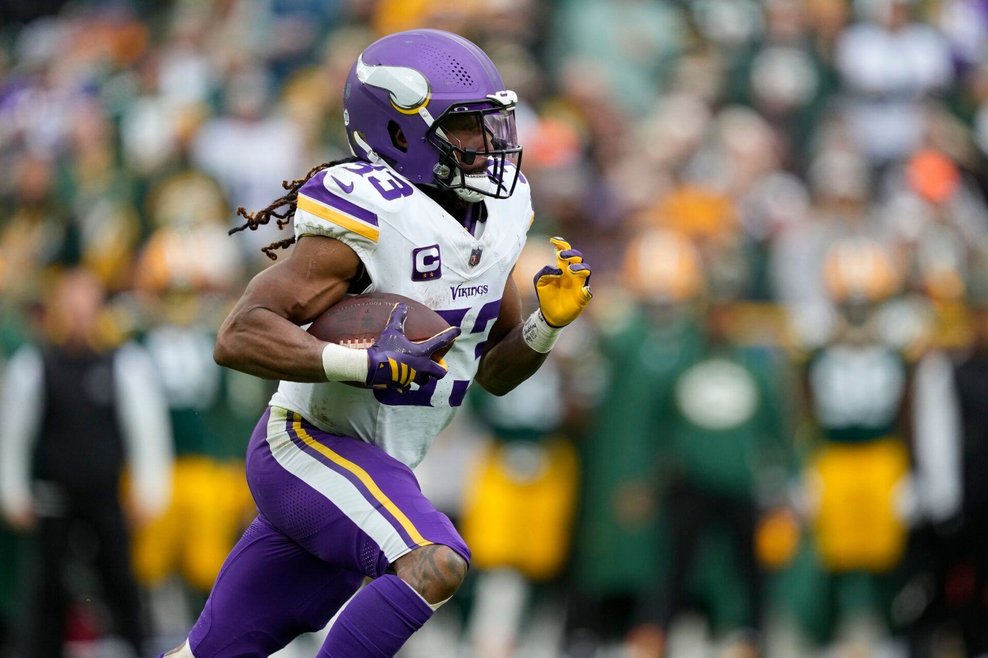 Minnesota Vikings running back Aaron Jones Sr. (33) carries the ball against the Green Bay Packers during the first half at Lambeau Field.