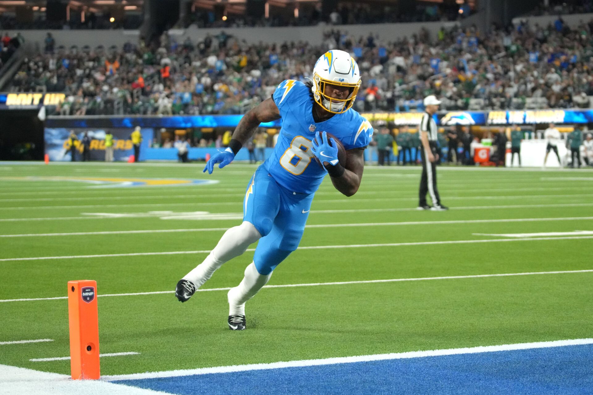 Los Angeles Chargers running back Omarion Hampton (8) runs for a touchdown against the Philadelphia Eagles in the first half at SoFi Stadium.
