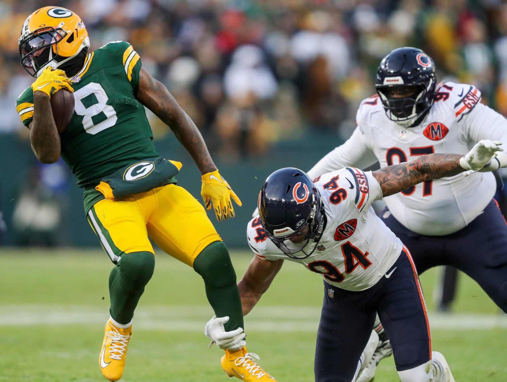 Green Bay Packers running back Josh Jacobs (8) is tripped up by Chicago Bears defensive end Austin Booker (94) on Sunday, December 7, 2025, at Lambeau Field in Green Bay, Wis. The Packers won the game, 28-21.
Tork Mason/USA TODAY NETWORK-Wisconsin