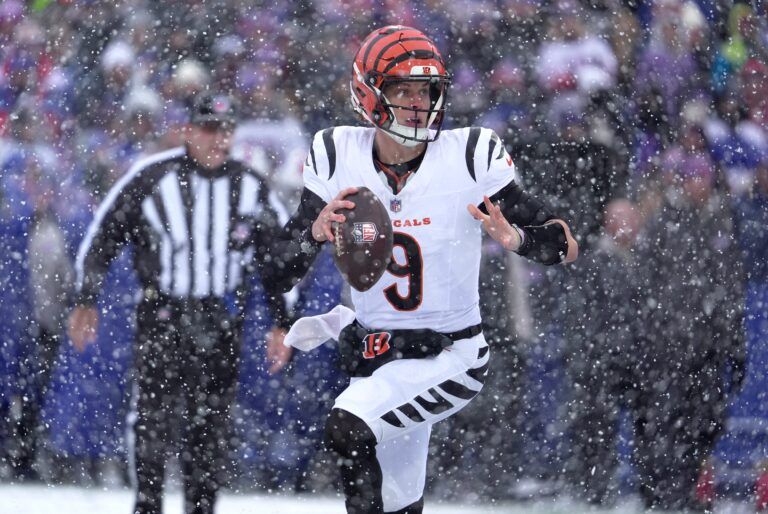 Cincinnati Bengals quarterback Joe Burrow runs to the sideline looking for an open receiver during first half action at Highmark Stadium in Orchard Park on Dec. 7, 2025.