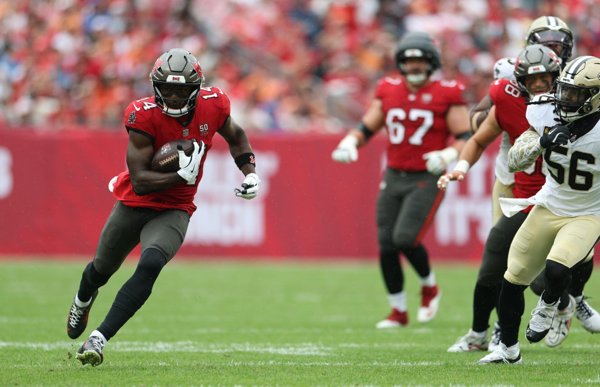 Tampa Bay Buccaneers wide receiver Chris Godwin Jr. (14) runs for a gain during the first quarter against the New Orleans Saints at Raymond James Stadium.