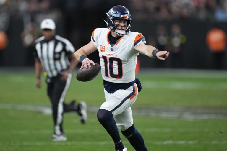 Denver Broncos quarterback Bo Nix (10) scrambles against the Las Vegas Raiders during the second half at Allegiant Stadium.