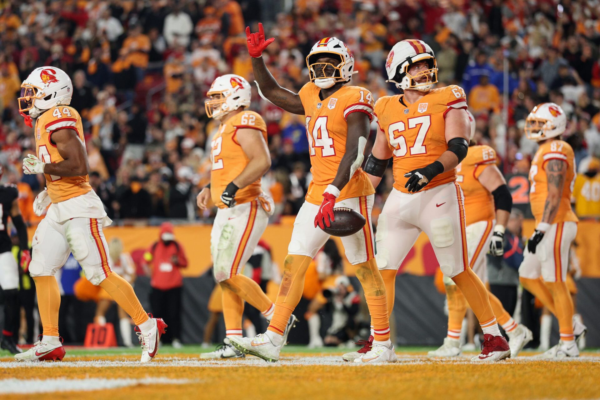 Tampa Bay Buccaneers wide receiver Chris Godwin Jr. (14) acknowledges the crowd with teammates after catching a three-yard touchdown pass thrown by quarterback Baker Mayfield (not pictured) against the Atlanta Falcons during the fourth quarter at Raymond James Stadium.