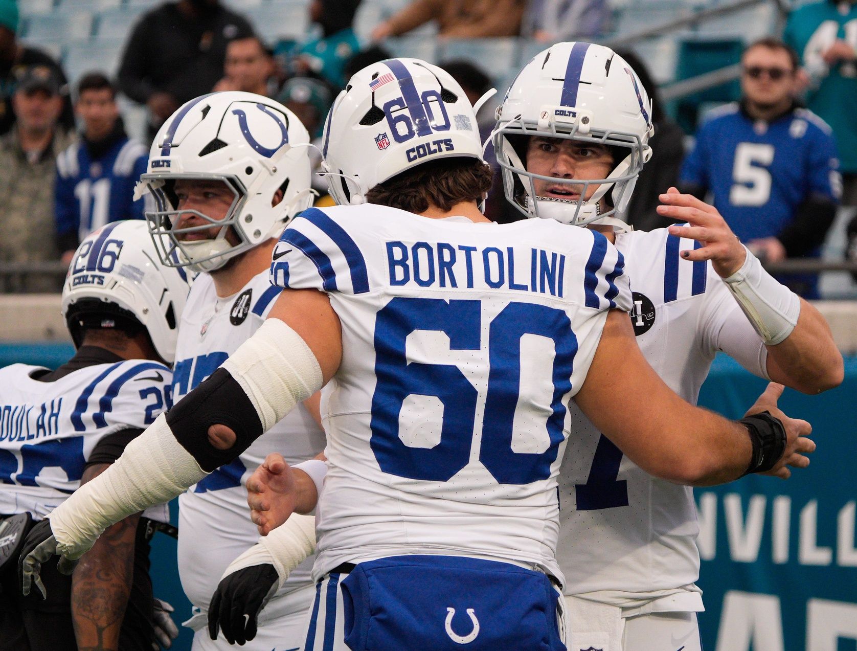 Indianapolis Colts quarterback Daniel Jones (17) gives Indianapolis Colts center Tanor Bortolini (60) a hug before an NFL football game at EverBank Stadium, Sunday, Dec. 7, 2025, in Jacksonville, Fla. [Doug Engle/Florida Times-Union]