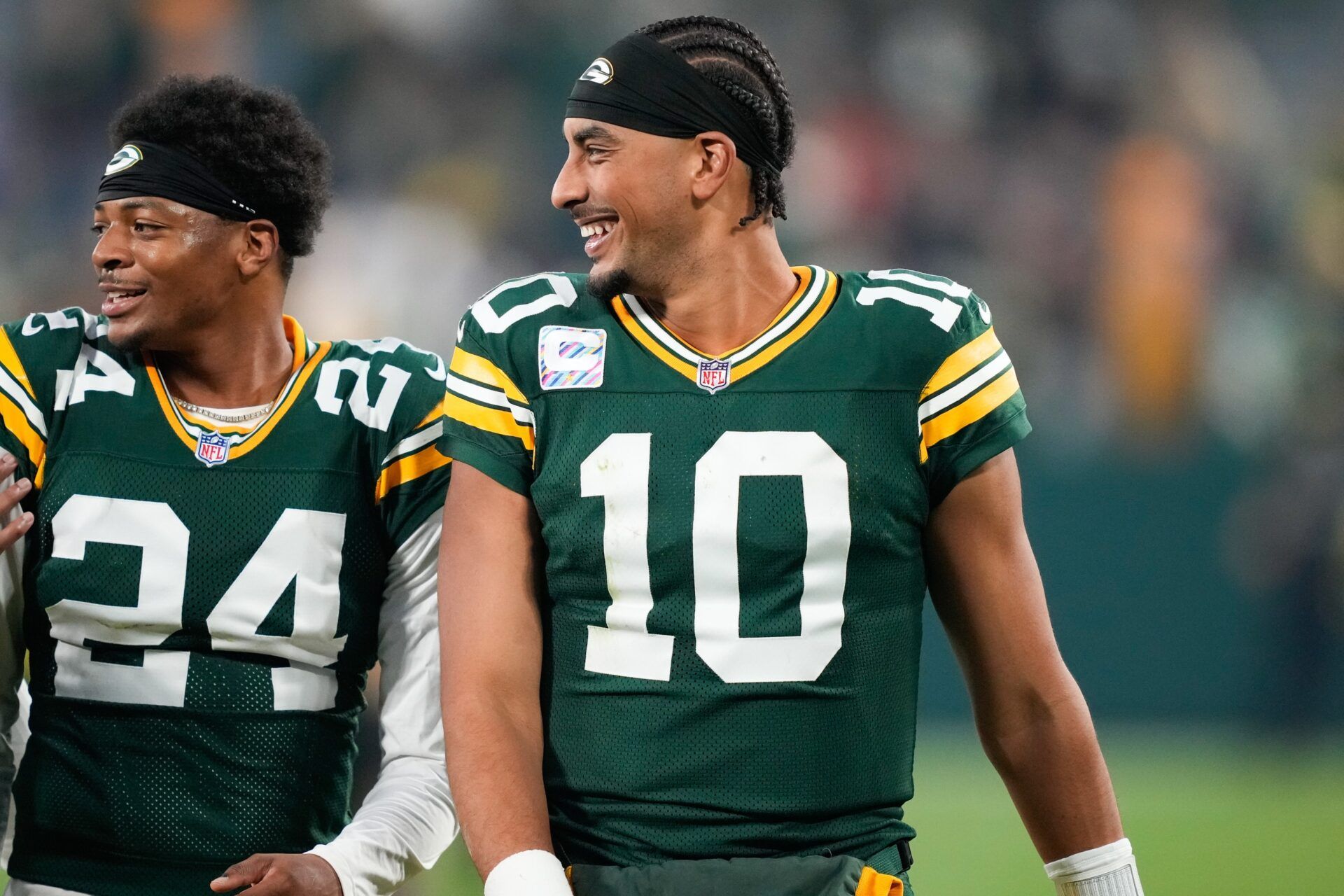 Green Bay Packers quarterback Jordan Love (10) reacts with cornerback Carrington Valentine (24) after the game against the Cincinnati Bengals at Lambeau Field.