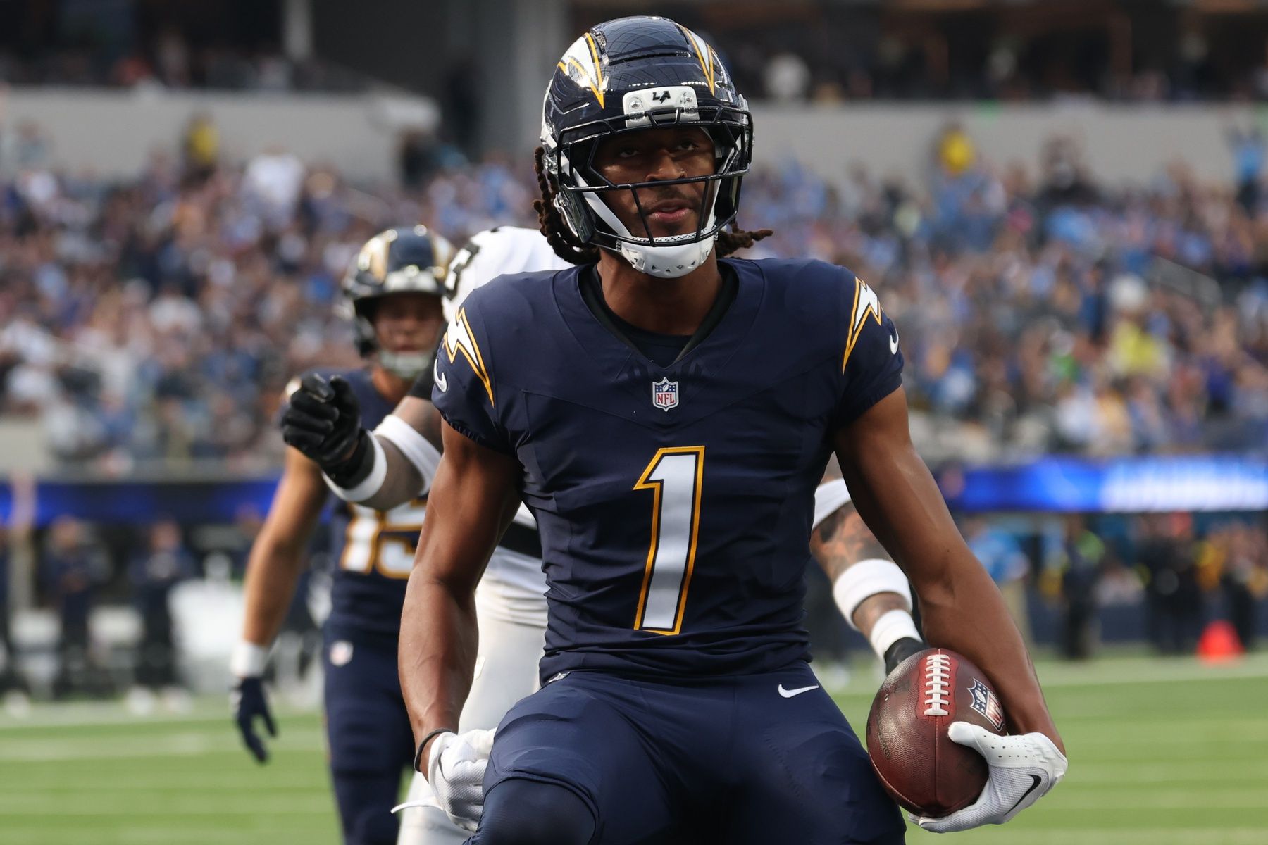 Los Angeles Chargers wide receiver Quentin Johnston (1) reacts after scoring a touchdown against the Las Vegas Raiders during the first half at SoFi Stadium.