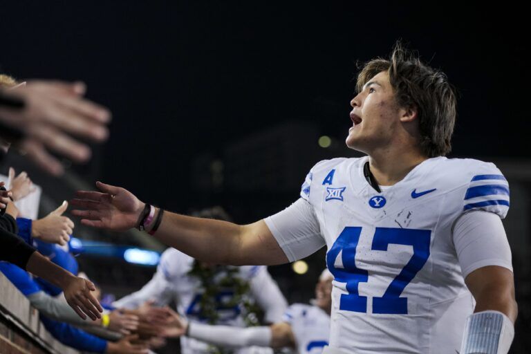 BYU Cougars quarterback Bear Bachmeier celebrates with fans after defeating the Cincinnati Bearcats at Nippert Stadium.