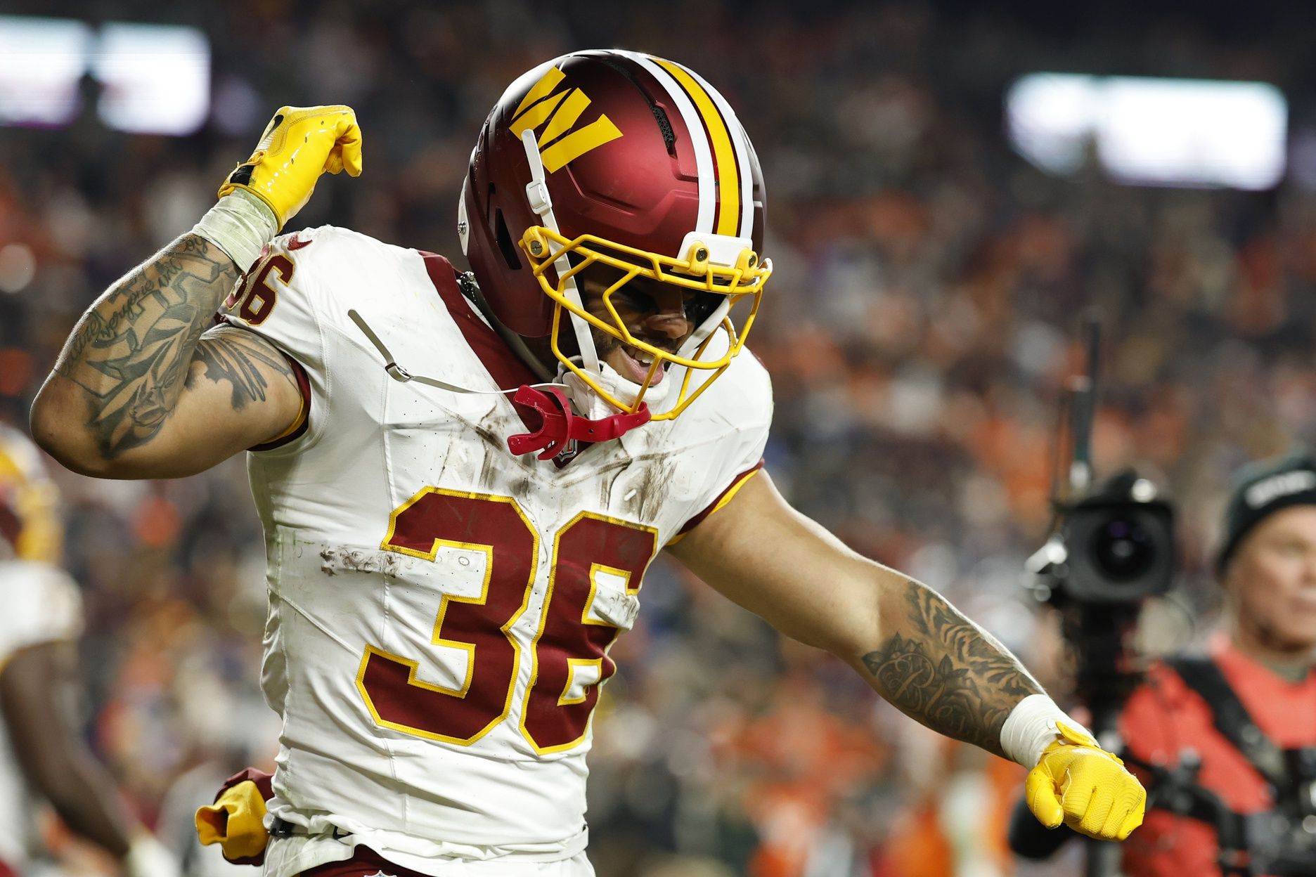 Washington Commanders running back Chris Rodriguez Jr. (36) celebrates after scoring a touchdown against the Denver Broncos in the second quarter at Northwest Stadium.