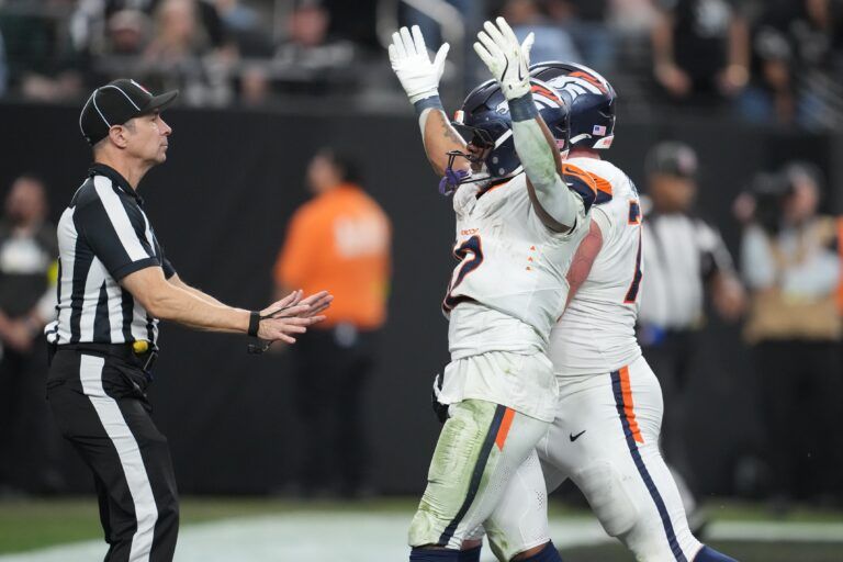 Denver Broncos running back RJ Harvey (12) reacts after scoring a touchdown against the Las Vegas Raiders during the second half at Allegiant Stadium.