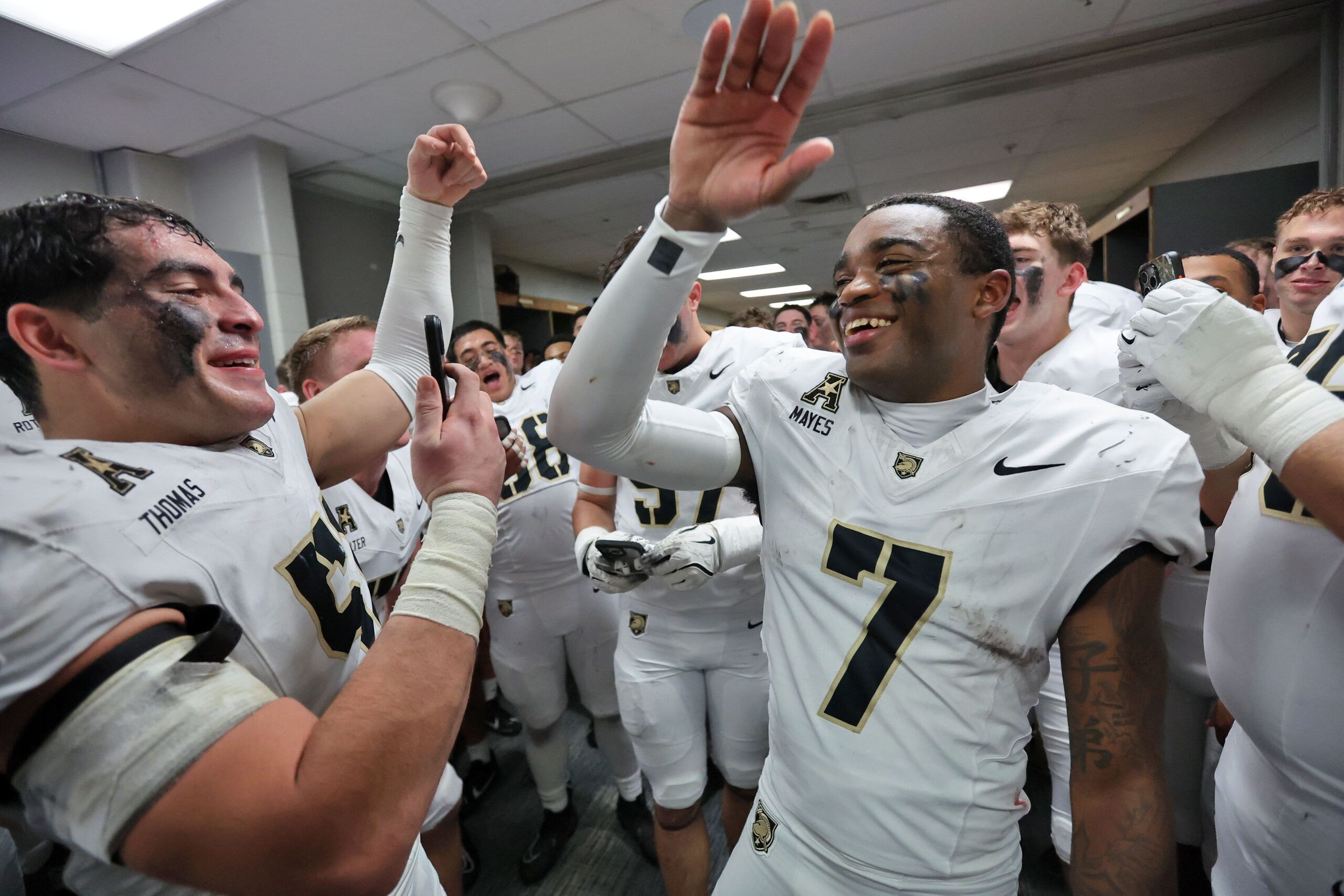 Army Black Knights cornerback Jaydan Mayes (7) celebrates a 27-24 win against the UTSA Roadrunners in the locker room with his teammates at the Alamodome.
