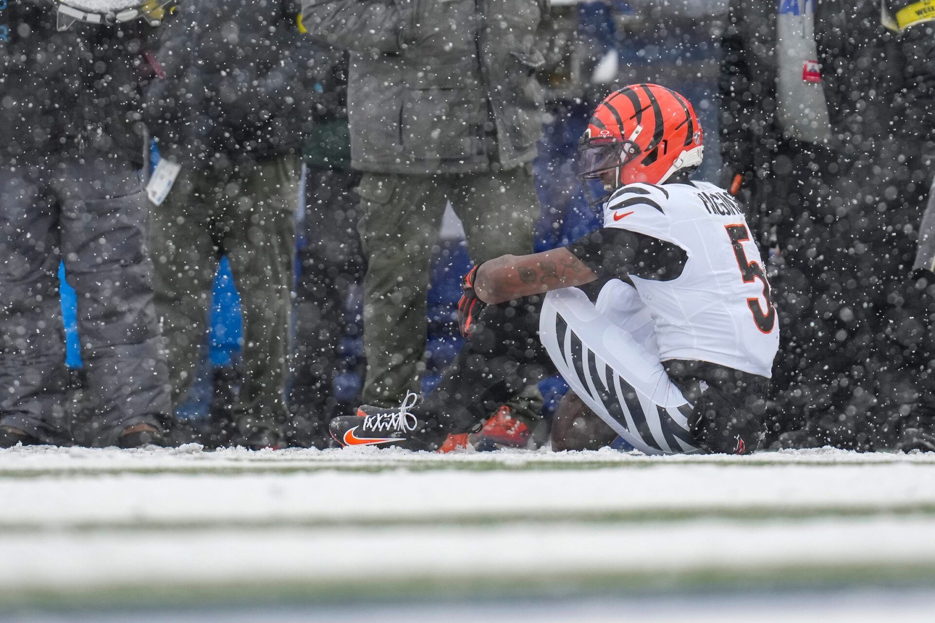 Cincinnati Bengals wide receiver Tee Higgins (5) waits for trainers after hitting his head on the ground on a catch in the second quarter of the NFL Week 14 game between the Buffalo Bills and the Cincinnati Bengals at Highmark Stadium in Orchard Park, N.Y., on Sunday, Dec. 7, 2025.