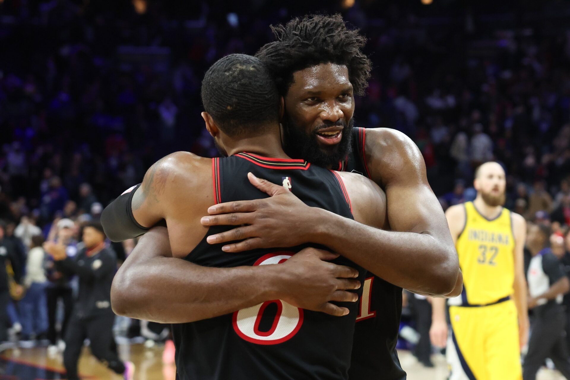 Philadelphia 76ers center Joel Embiid (21) hugs Paul George (8) after a victoryagainst the Indiana Pacers during at Xfinity Mobile Arena.
