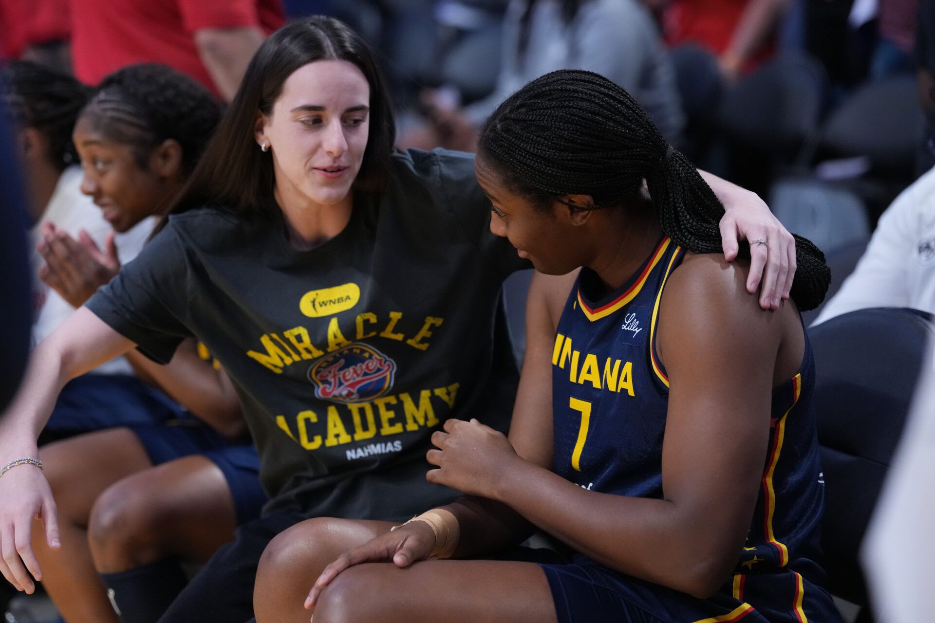 Indiana Fever guard Caitlin Clark (22) gives a hug to forward Aliyah Boston (7) in the first half against the LA Sparks at Crypto.com Arena.