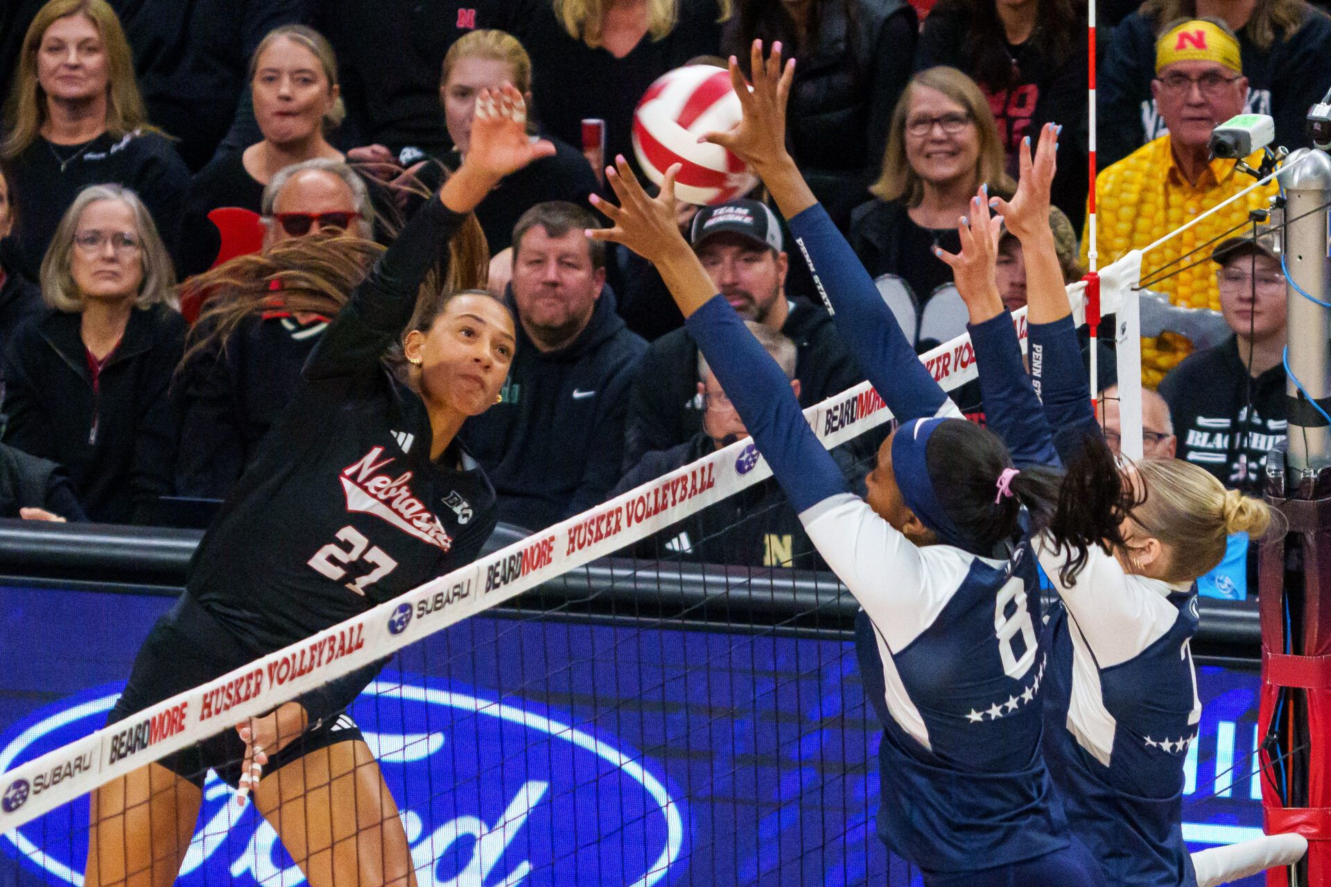 Nebraska Cornhuskers outside hitter Harper Murray (27) attacks against Penn State Nittany Lions middle blocker Gabrielle Nichols (8) and outside hitter Emmi Sellman (13) during the first set at Bob Devaney Sports Center.