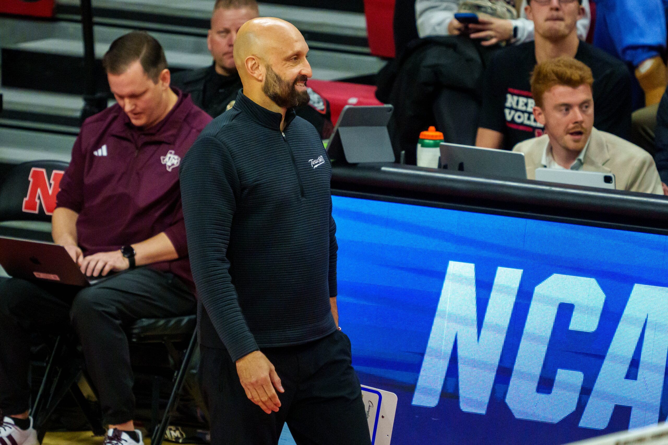 Texas A&M Aggies head coach Jamie Morrison walks along the bench during the first set against the Louisville Cardinals at Bob Devaney Sports Center.