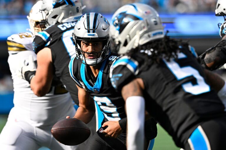 Carolina Panthers quarterback Bryce Young (9) fakes a handoff to running back Rico Dowdle (5) in the third quarter at Bank of America Stadium.