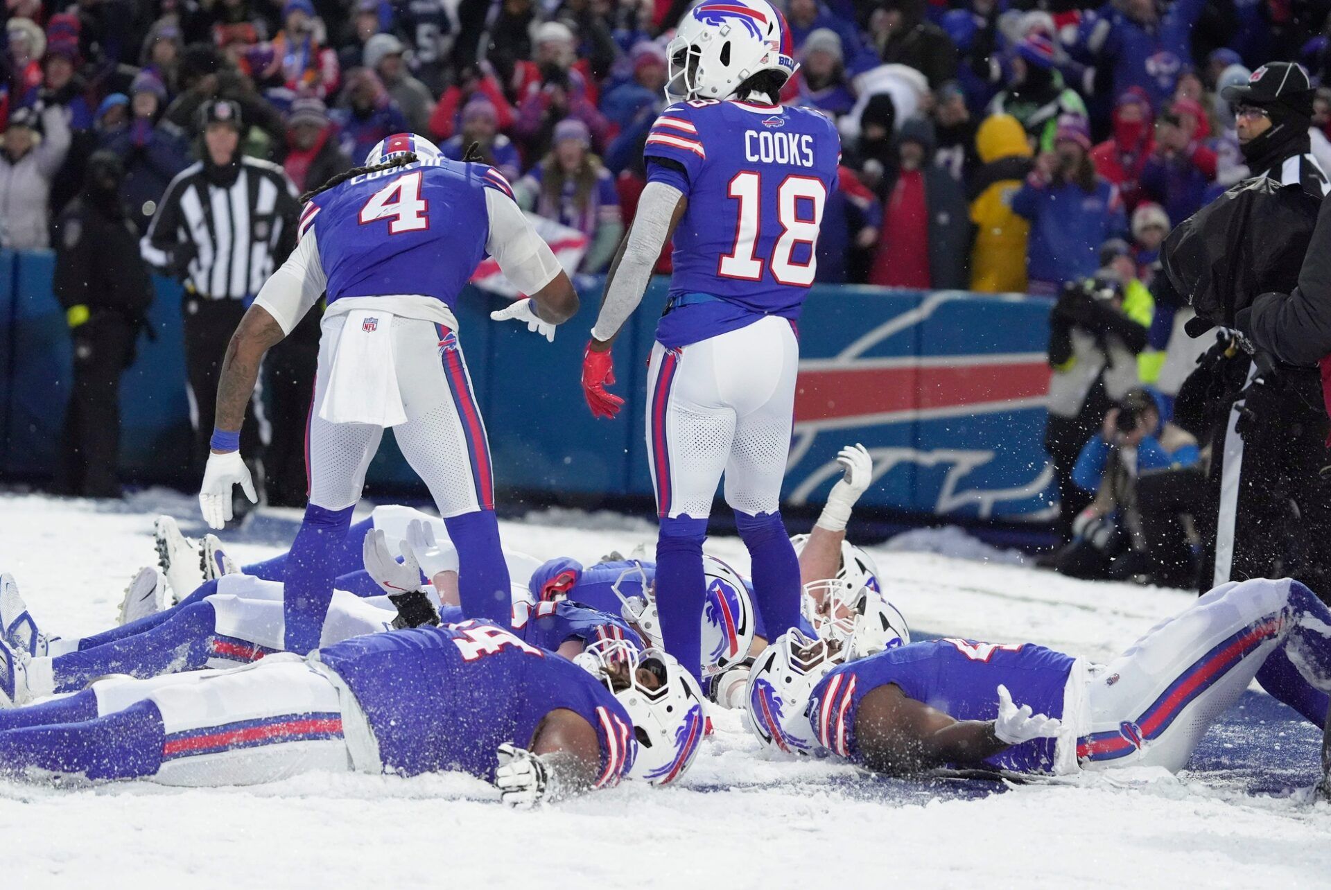 Bills offensive players drop and make snow angels joining Buffalo Bills tight end Jackson Hawes who was making a snow angel after catchingt a pass in the end zone for a touchdown during second half action at Highmark Stadium in Orchard Park on Dec. 7, 2025.
