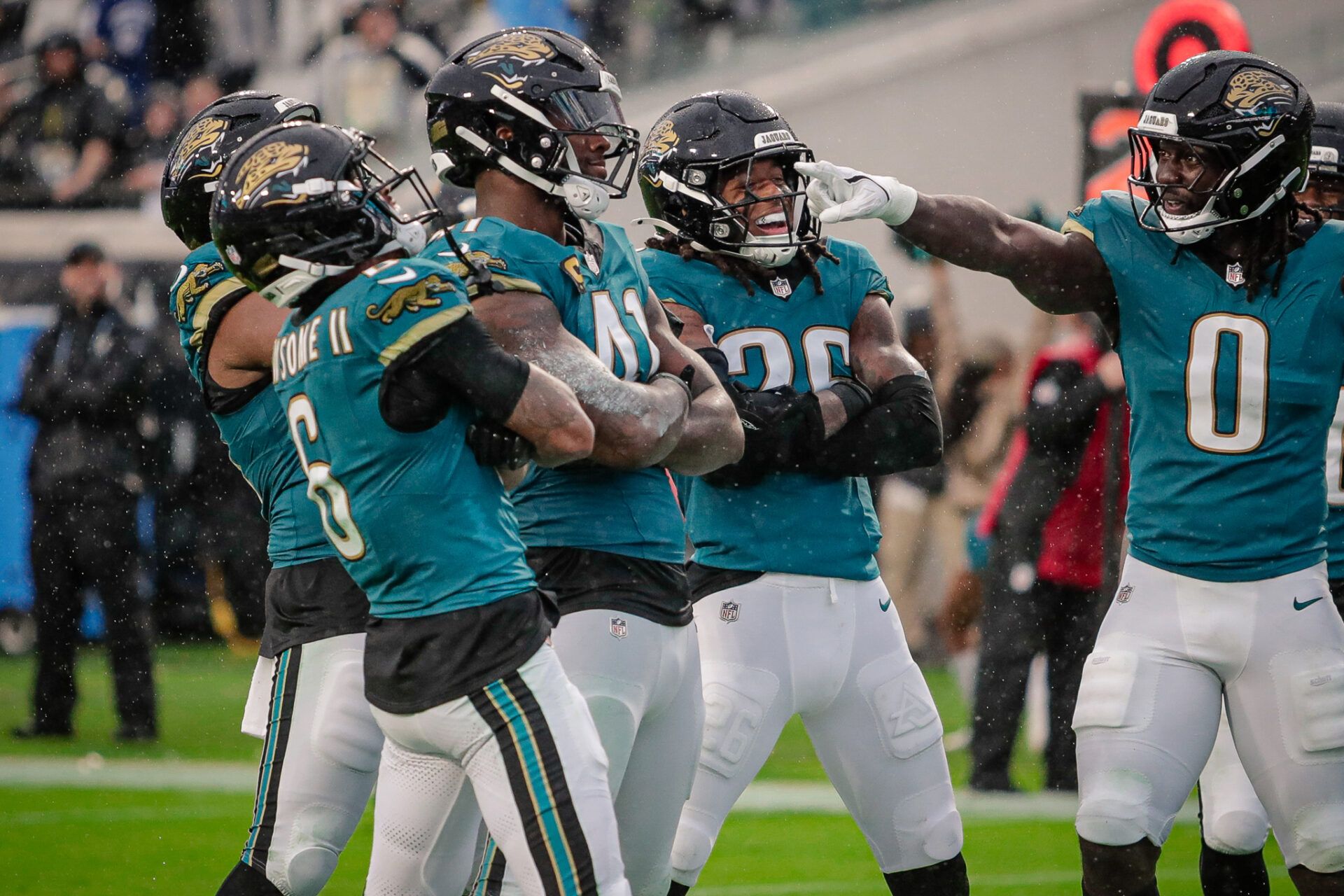 Jacksonville Jaguars defensive end Josh Hines-Allen (41), linebacker Devin Lloyd (0), and the Jaguars defense celebrate after a play against the Indianapolis Colts at EverBank Stadium.