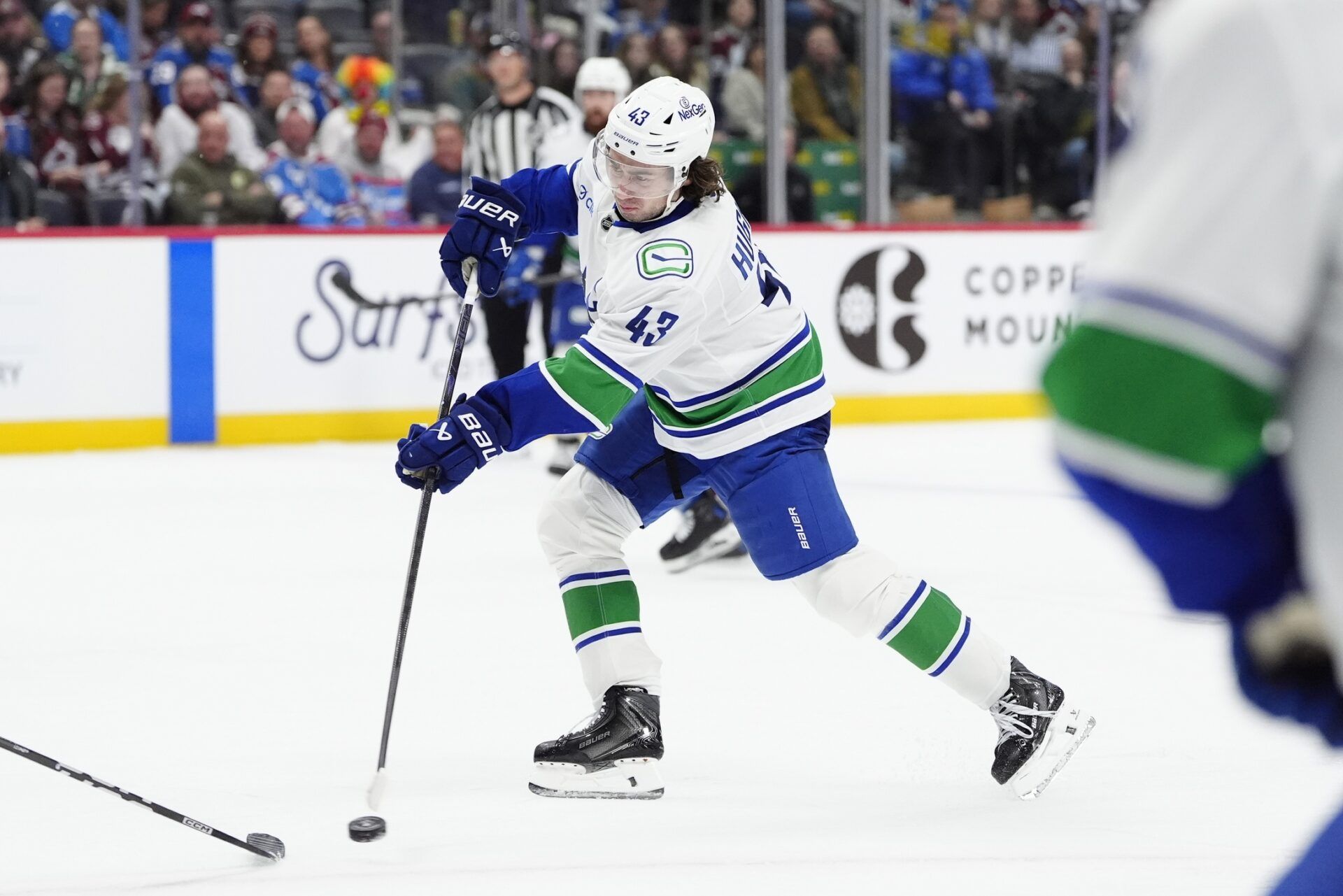 Vancouver Canucks defenseman Quinn Hughes (43) takes a shot on goal in the third period against the Colorado Avalanche at Ball Arena.