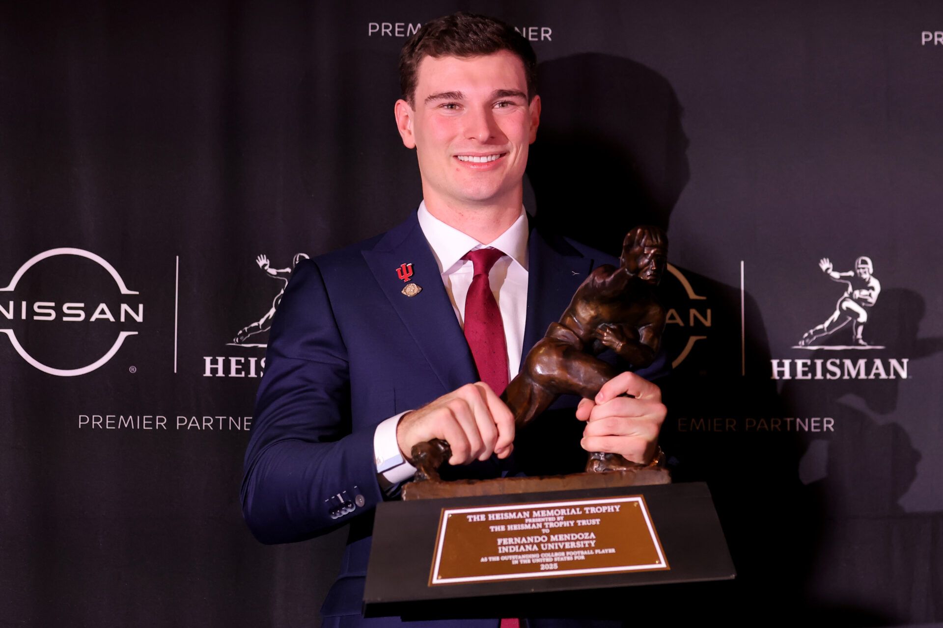 Indiana Hoosiers quarterback Fernando Mendoza poses for photos with the Heisman trophy during a press conference at the New York Marriott Marquis after winning the award.