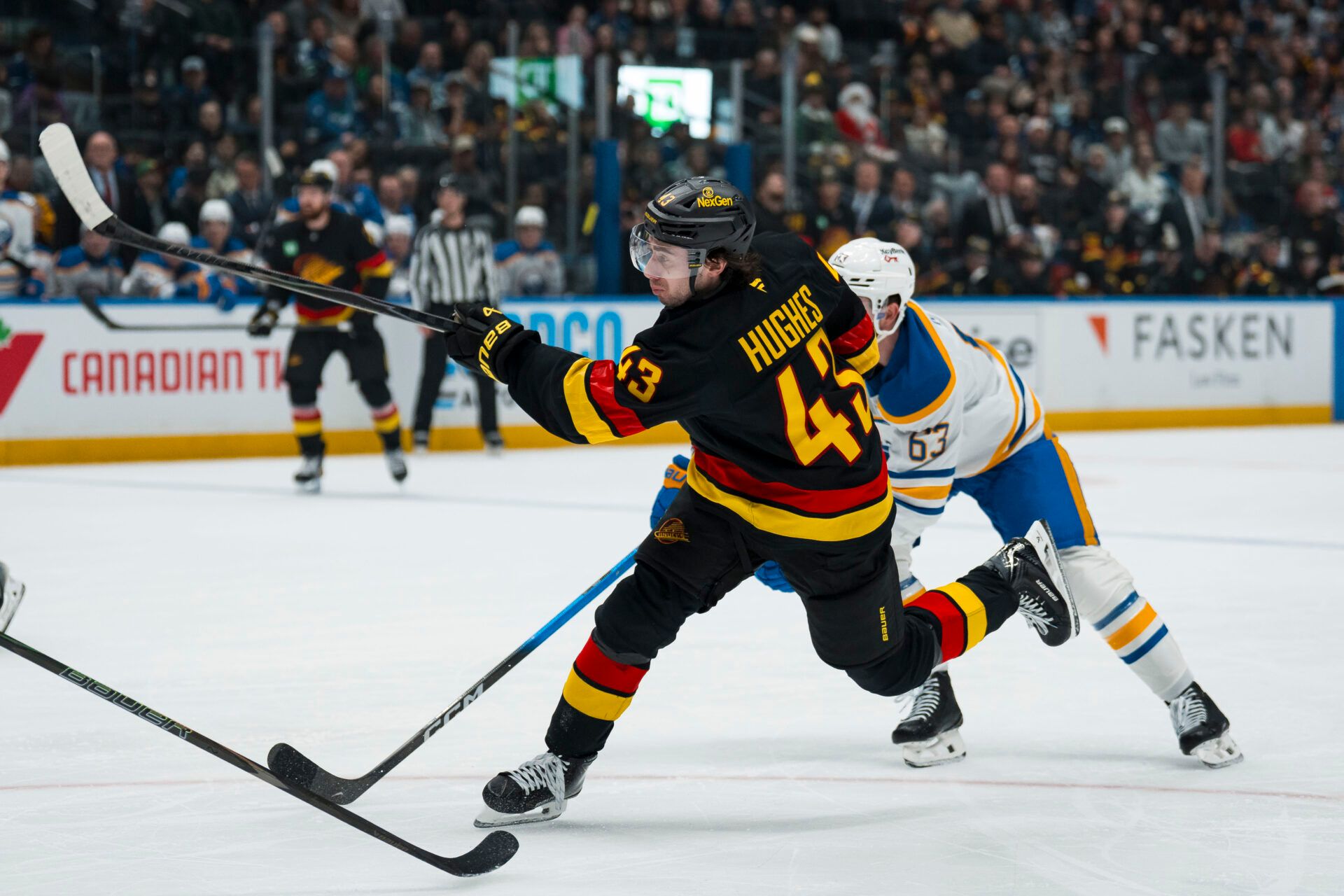 Vancouver Canucks defenseman Quinn Hughes (43) shoots against the Buffalo Sabres in the first period at Rogers Arena.