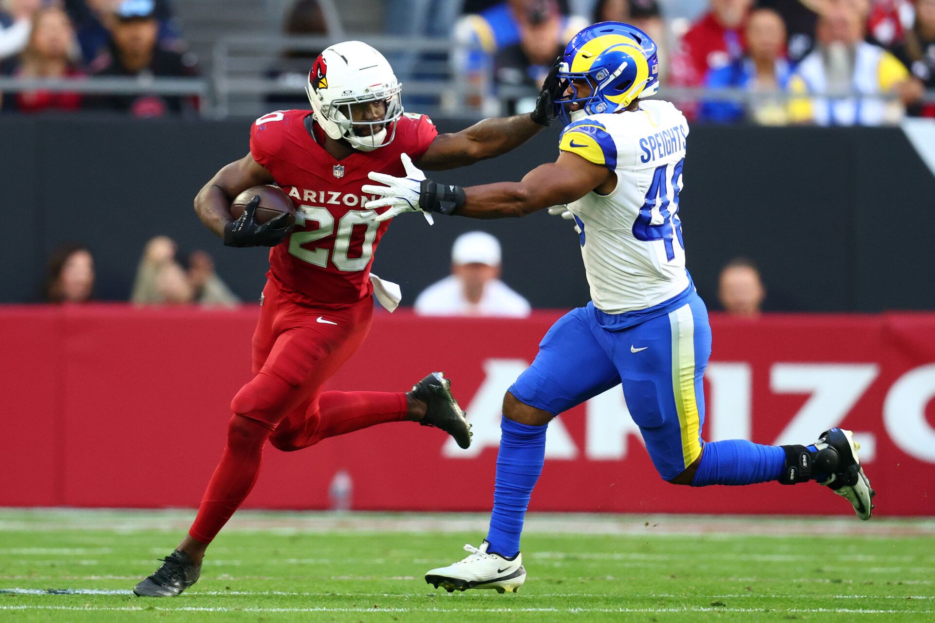 Arizona Cardinals running back Bam Knight (20) rushes the ball past Los Angeles Rams linebacker Omar Speights (48) during the first half at State Farm Stadium.