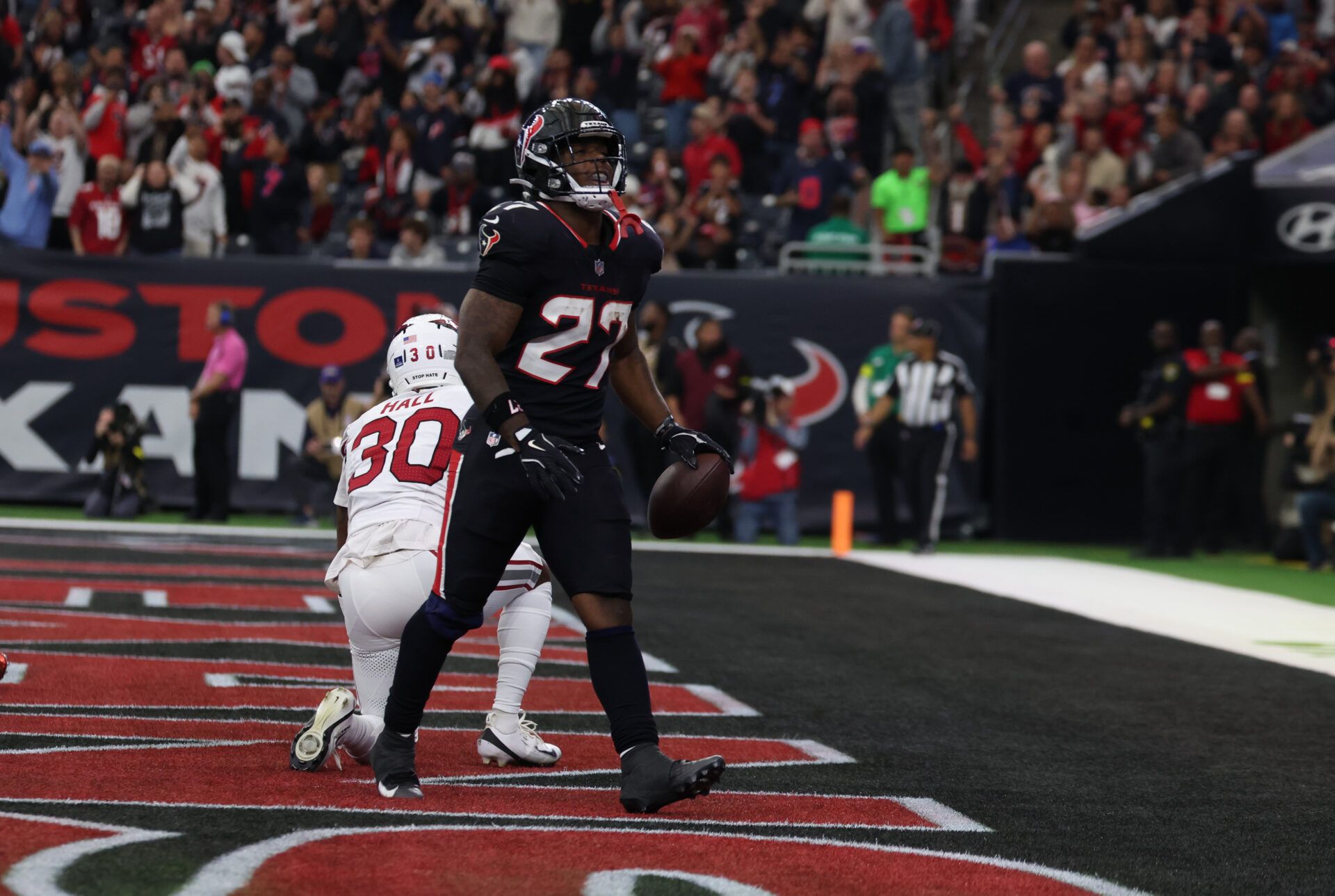 Houston Texans running back Woody Marks (27) celebrates a touchdown during the first quarter against the Arizona Cardinals at NRG Stadium.