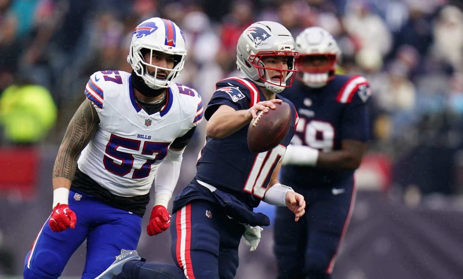 New England Patriots quarterback Drake Maye (10) runs the ball against the Buffalo Bills in the first half at Gillette Stadium.