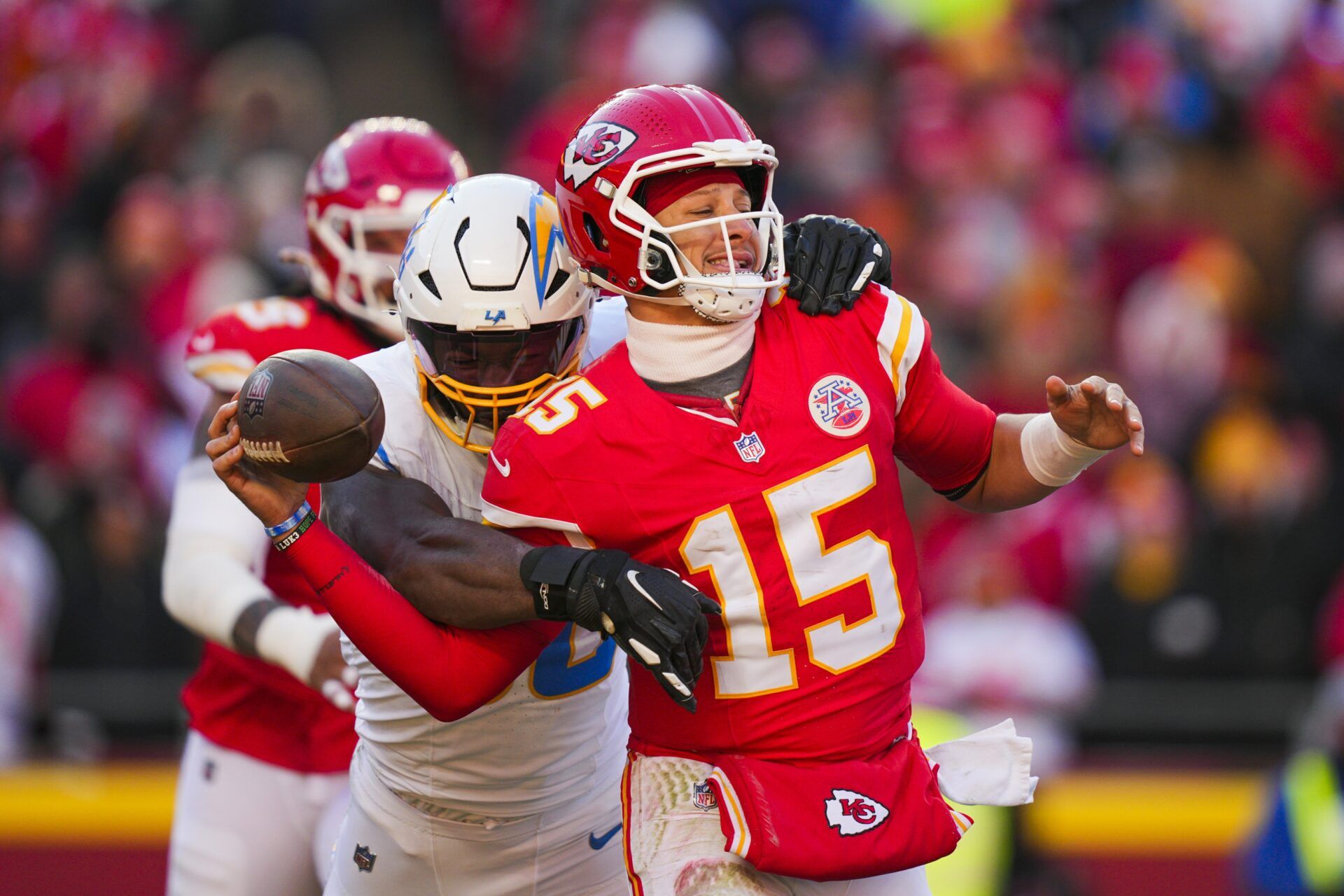 Los Angeles Chargers linebacker Odafe Oweh (98) sacks Kansas City Chiefs quarterback Patrick Mahomes (15) during the second half at GEHA Field at Arrowhead Stadium.