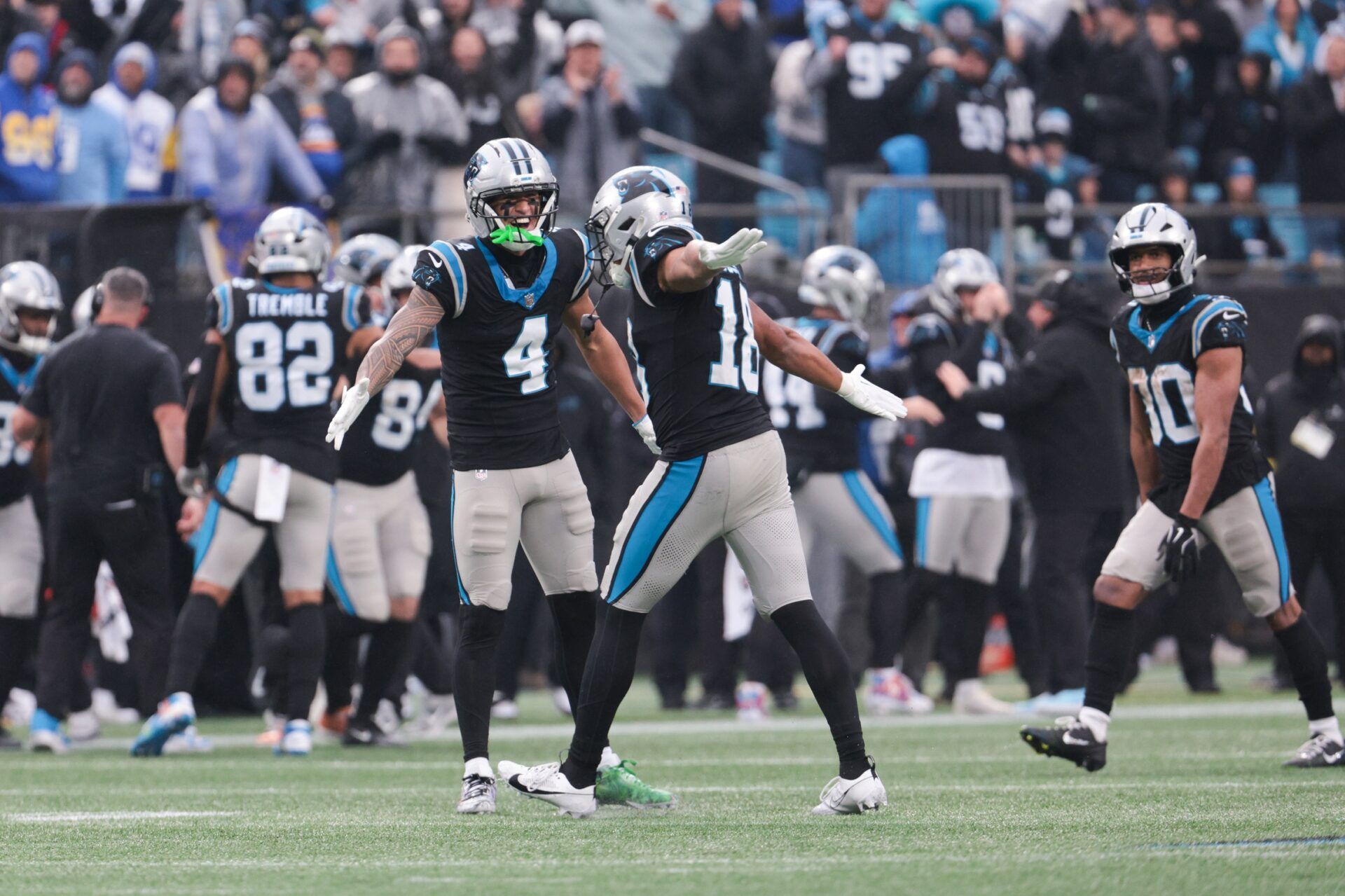 Carolina Panthers wide receiver Tetairoa McMillan (4) celebrates with Carolina Panthers wide receiver Jalen Coker (18) after a play during the fourth quarter against the Los Angeles Rams at Bank of America Stadium.
