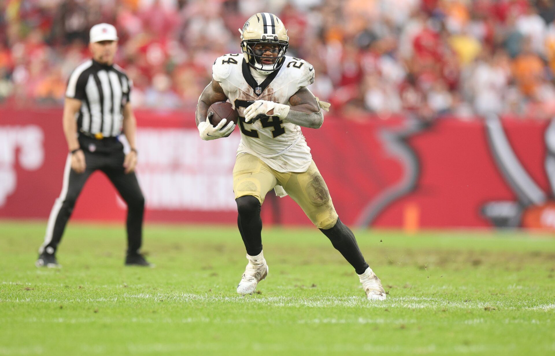 New Orleans Saints running back Devin Neal (24) runs for a gain during the fourth quarter against the Tampa Bay Buccaneers at Raymond James Stadium.