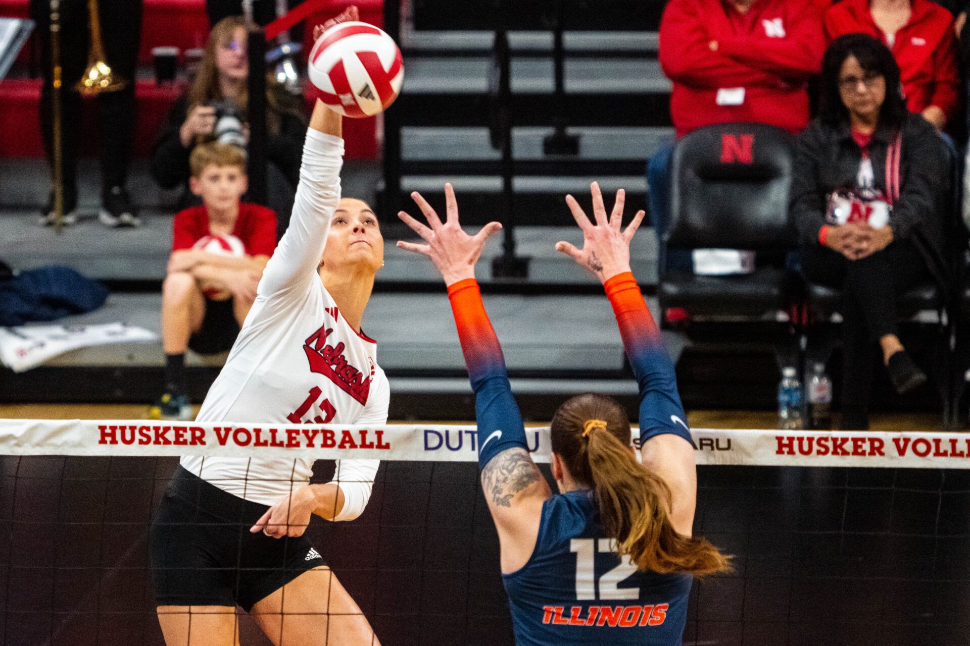 Nebraska Cornhuskers outside hitter Merritt Beason (13) attacks against Illinois Fighting Illini outside hitter Raina Terry (12) during the third set at Bob Devaney Sports Center.