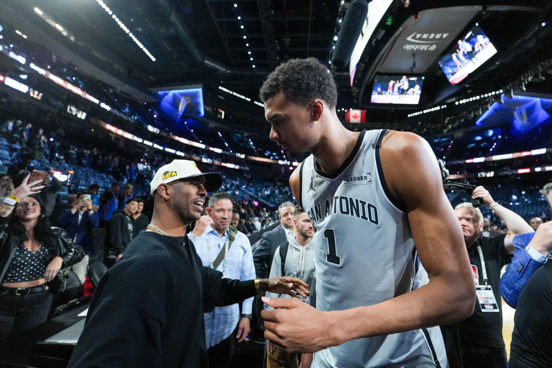 San Antonio Spurs forward Victor Wembanyama (1) celebrates with Chris Paul after the game against the Oklahoma City Thunder at T-Mobile Arena.