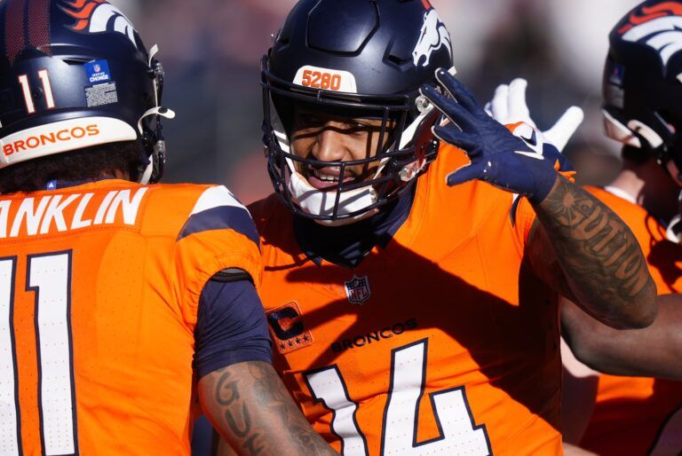 Denver Broncos wide receiver Courtland Sutton (14) and wide receiver Troy Franklin (11) hug during warmups for a game against the Green Bay Packers at Empower Field at Mile High.