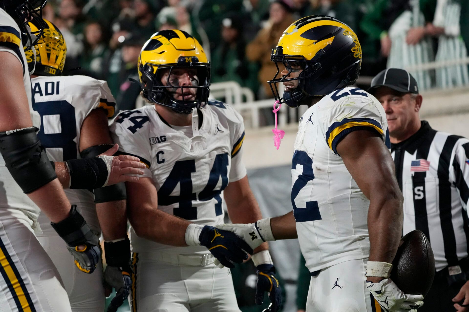 Michigan Wolverines running back Justice Haynes (22) reacts with tight end Max Bredeson (44) after scoring a touchdown against the Michigan Wolverines during the second half at Spartan Stadium.