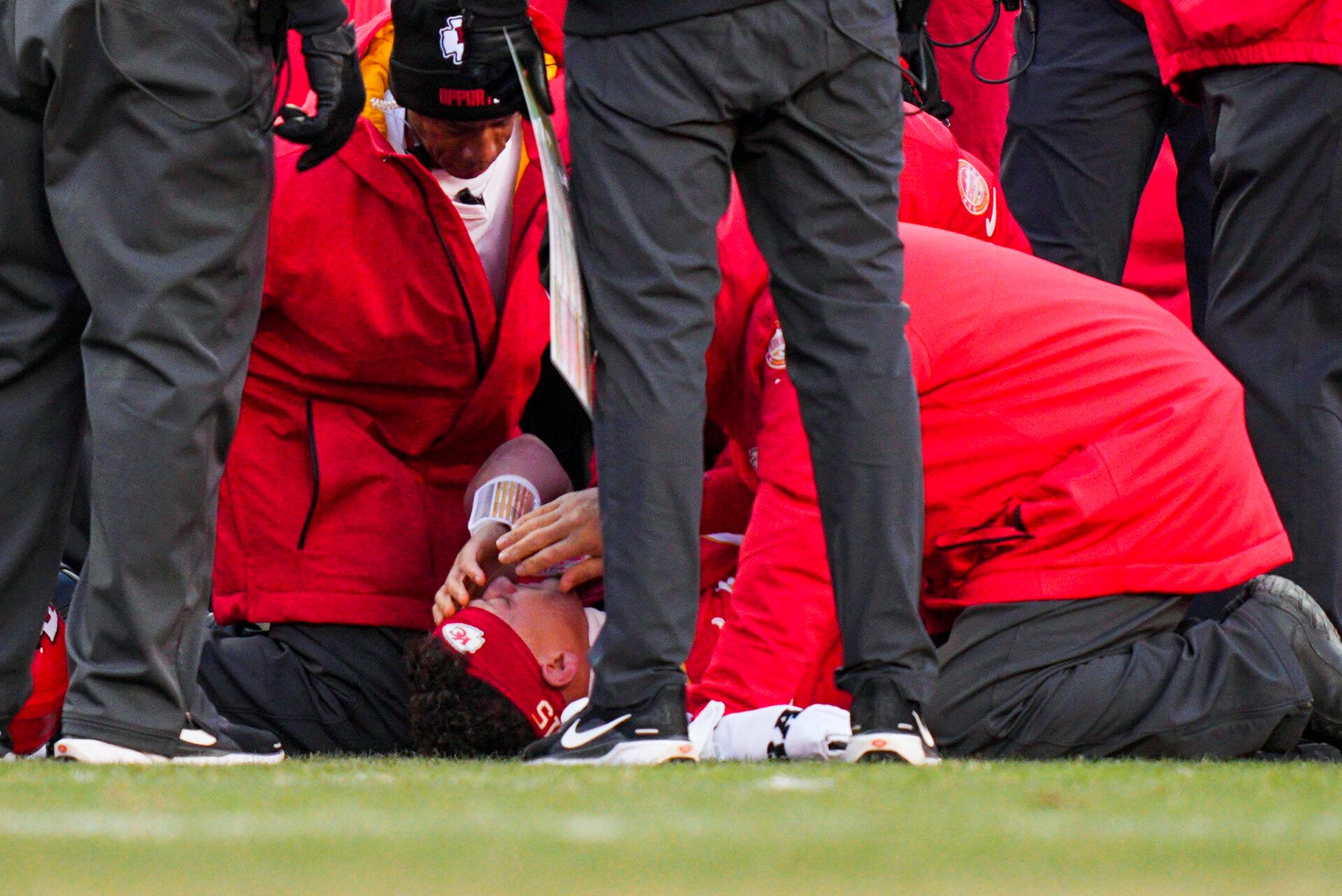 Kansas City Chiefs quarterback Patrick Mahomes (15) is attended to by team medical staff following an injury during the fourth quarter against the Los Angeles Chargers at GEHA Field at Arrowhead Stadium.
