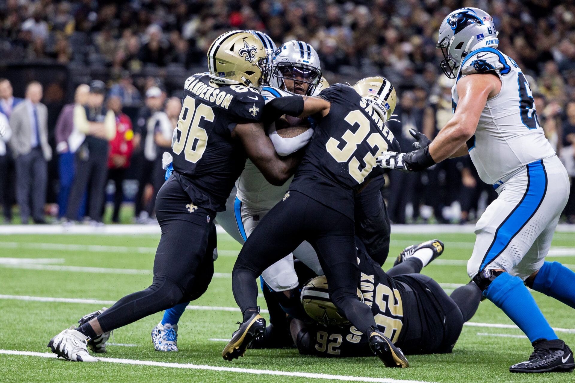 New Orleans Saints defensive end Carl Granderson (96) and safety Jonas Sanker (33) tackle the Carolina Panthers during the second quarter at Caesars Superdome.