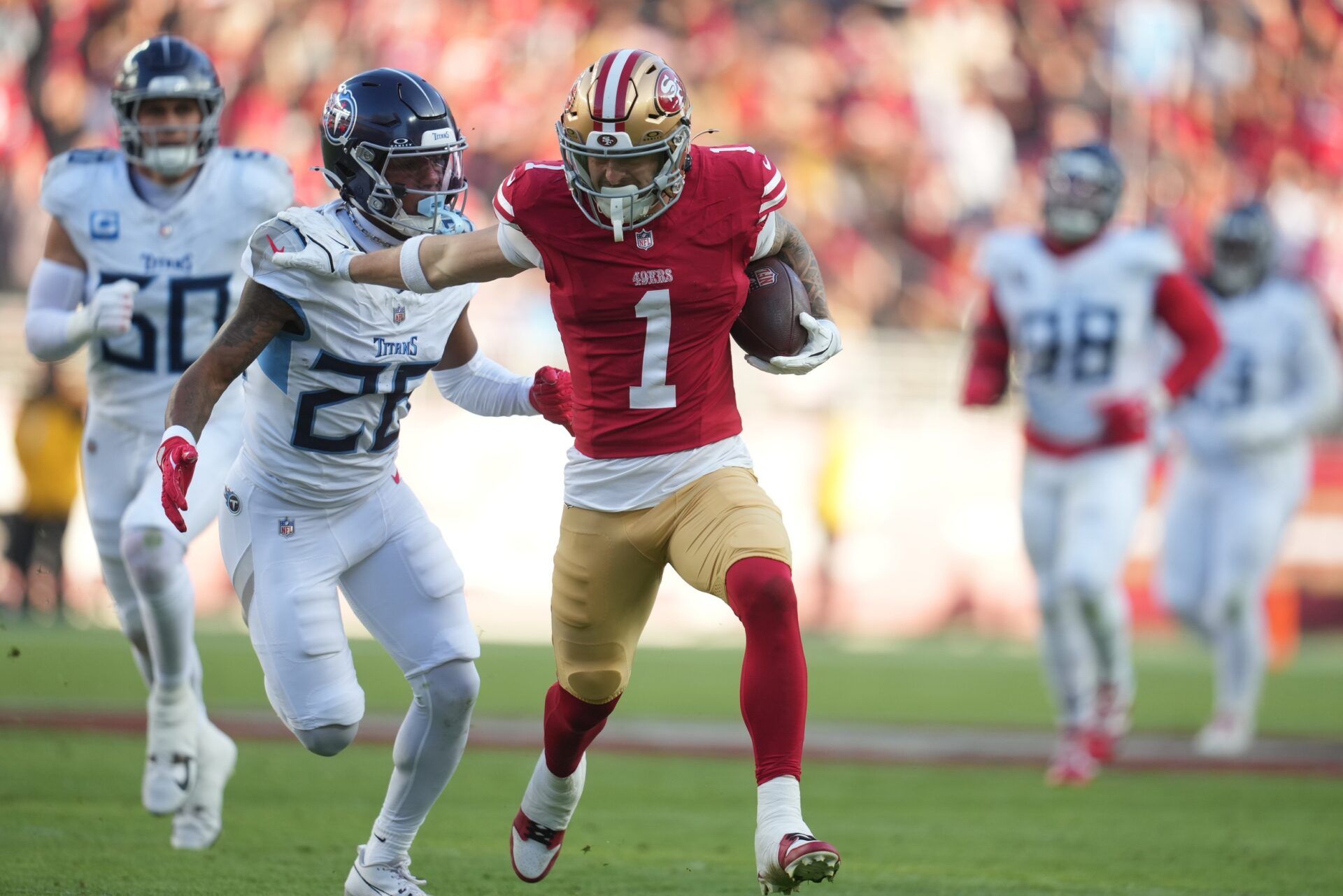 San Francisco 49ers wide receiver Ricky Pearsall (1) stiff arms Tennessee Titans cornerback Marcus Harris (26) during the third quarter at Levi's Stadium.