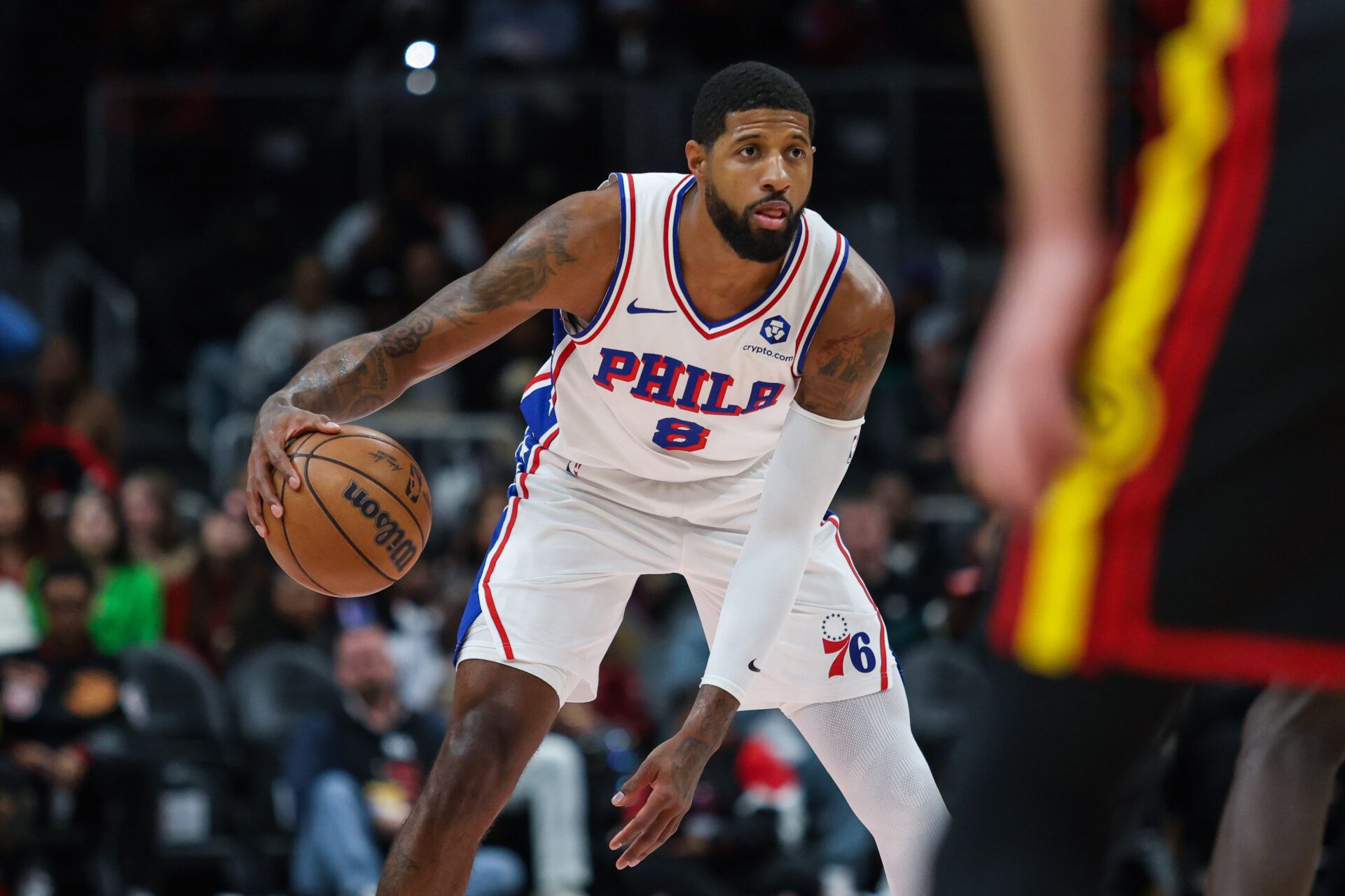 Philadelphia 76ers forward Paul George (8) dribbles the ball against the Atlanta Hawks during the first quarter at State Farm Arena.
