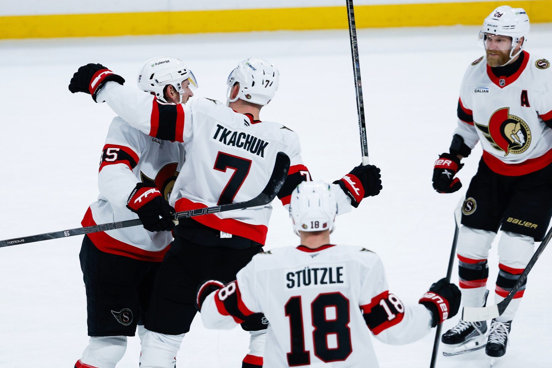Ottawa Senators defenseman Jake Sanderson (85) is congratulated by Ottawa Senators forward Brady Tkachuk (7) on his goal against the Winnipeg Jets during the third period at Canada Life Centre.