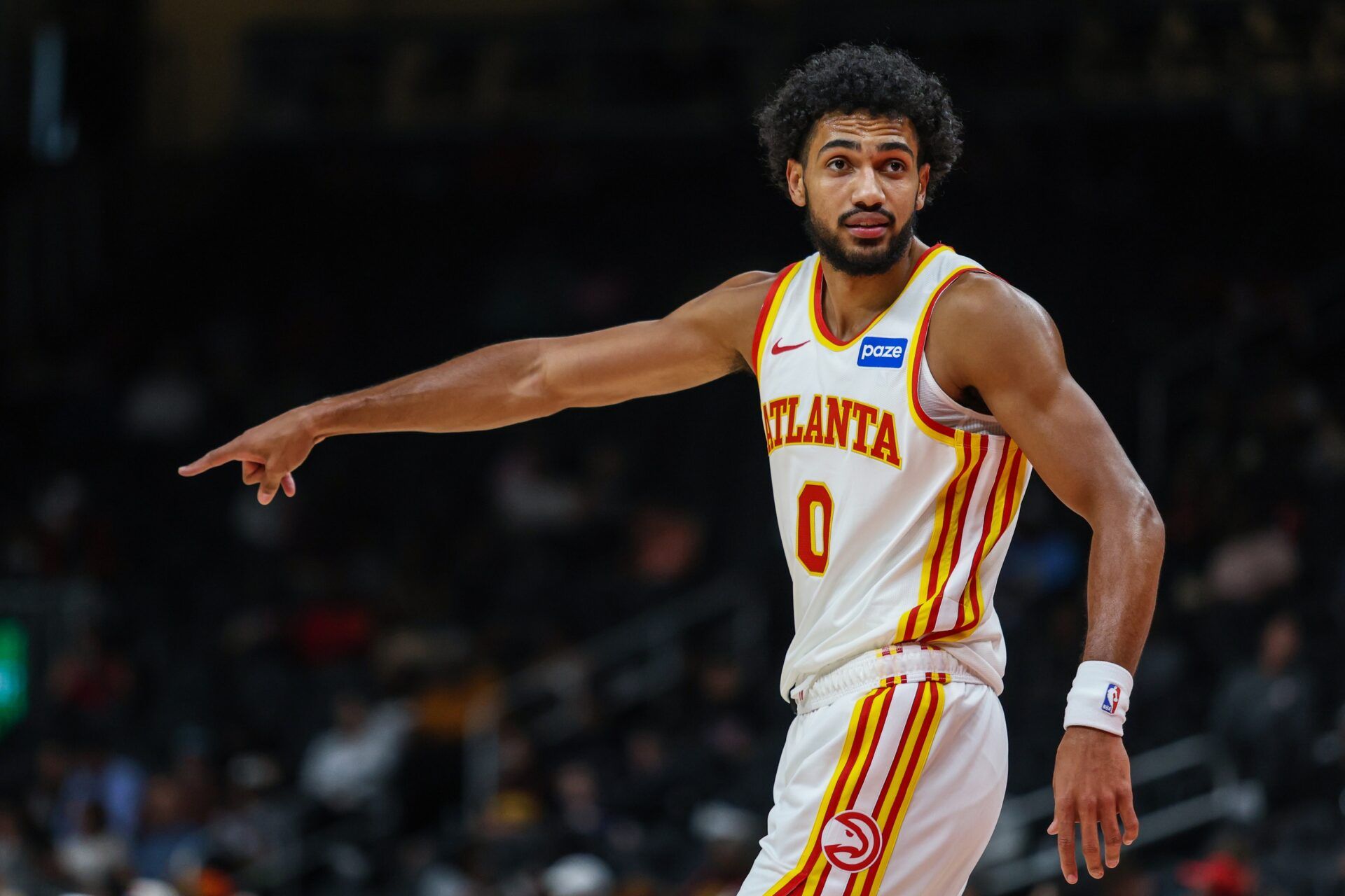 Atlanta Hawks forward Jacob Toppin (0) points while talking to a teammate during the game against the Miami Heat during the first quarter at State Farm Arena.
