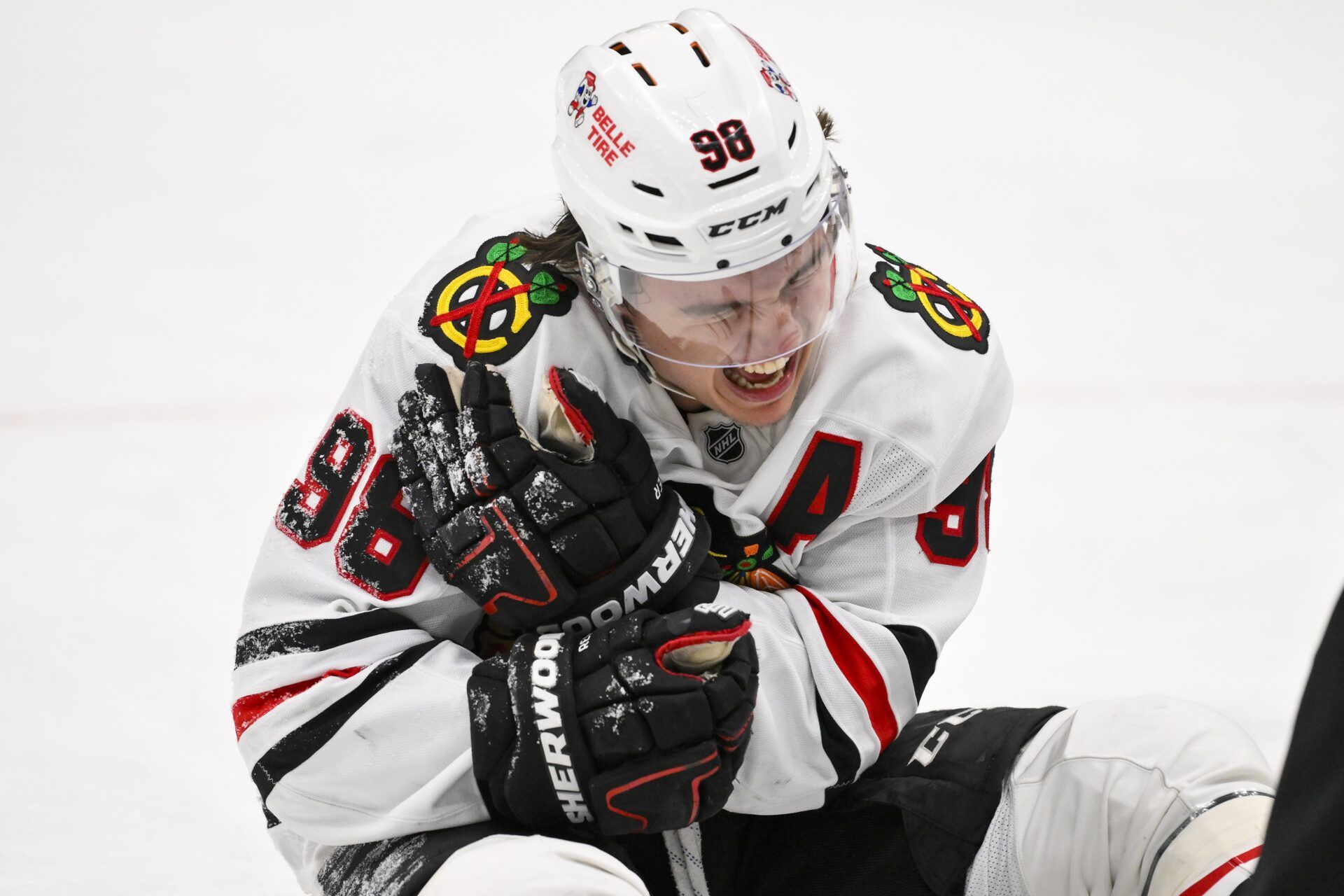 Chicago Blackhawks center Connor Bedard (98) reacts in pain after a face off against St. Louis Blues center Brayden Schenn (not pictured) during the third period at Enterprise Center.